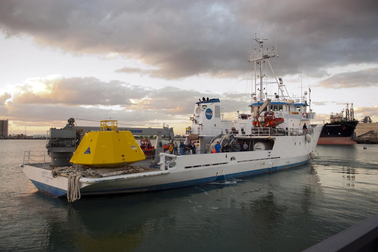 CAPE CANAVERAL, Fla. – NASA's Liberty Star ship departs Port Canaveral in Florida with an Orion flight test capsule secured to its deck. Liberty Star has been enlisted to support the Crew Module Recovery Attach Fitting Test (CRAFT) which began at-sea operations Nov. 29. Multiple attach clips are being evaluated against the current recovery cleat configuration by U.S. Air Force pararescue jumpers (PJs) and a U.S. Navy diver. The 21st Century Ground Systems Program will use data collected from the tests to help develop ground operations support equipment that could be used to recover an uncrewed Orion flight test capsule after splashdown. The Orion Multi-Purpose Crew Vehicle is NASA's next-generation spacecraft being developed for deep space missions to asteroids, moons and other interplanetary destinations throughout the solar system. For more information, visit http://www.nasa.gov/orion. Photo credit: NASA/Tim Jacobs