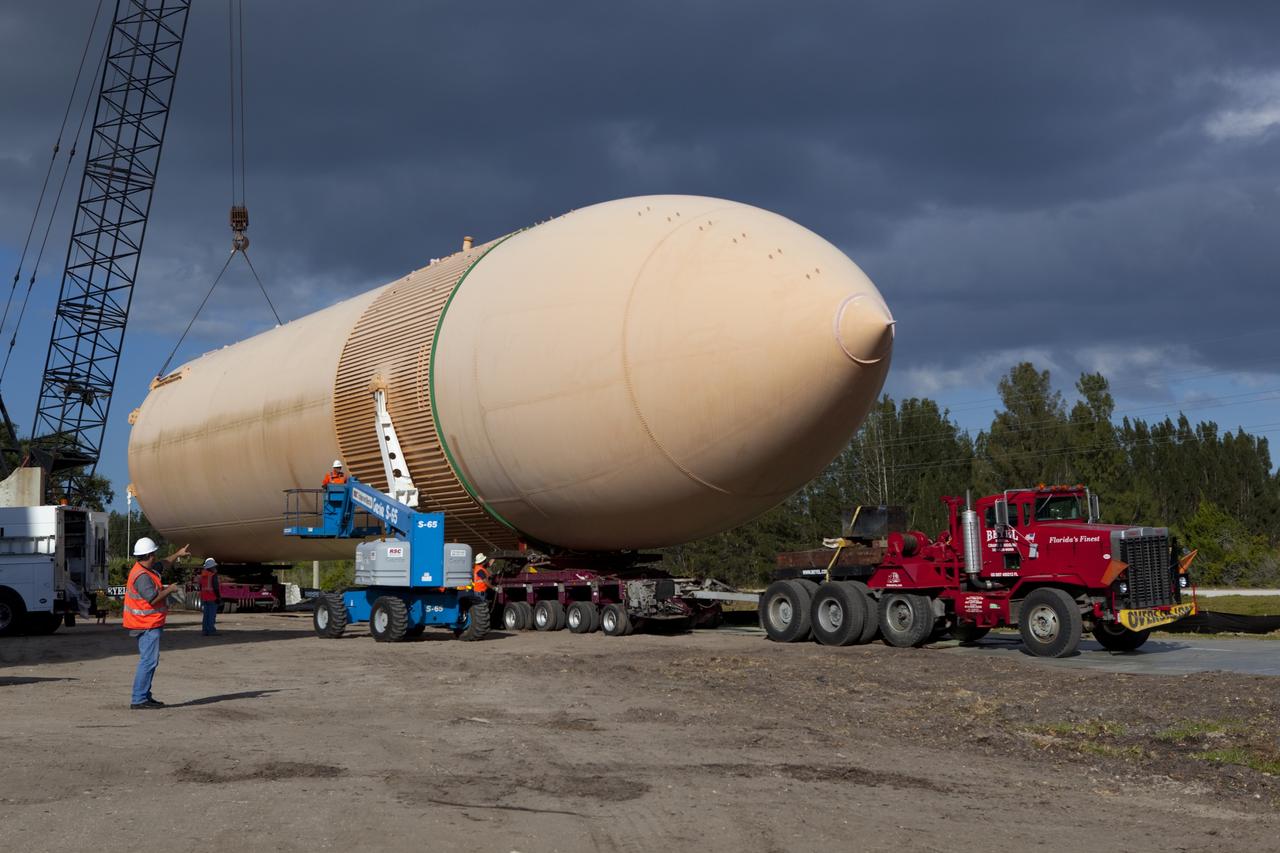 CAPE CANAVERAL, Fla. – A crane positions a full-size display of a space shuttle external fuel tank onto a truck to move it from the Kennedy Space Center Visitor Complex as the space-themed attraction makes way for a new exhibit featuring space shuttle Atlantis, which is currently undergoing preparations to go on public display. The tank is being placed into temporary storage at NASA's Kennedy Space Center. The tank was part of a display of the external tank and two solid rocket boosters at the visitor complex that were used to show visitors the size of actual space shuttle components. A space shuttle rode piggyback on the tank and boosters at liftoff and during the ascent into space. The tank, which held propellants for the shuttle's three main engines, was not reused, but burned up in the atmosphere and fell into the ocean. Photo credit: NASA/Dmitri Gerondidakis