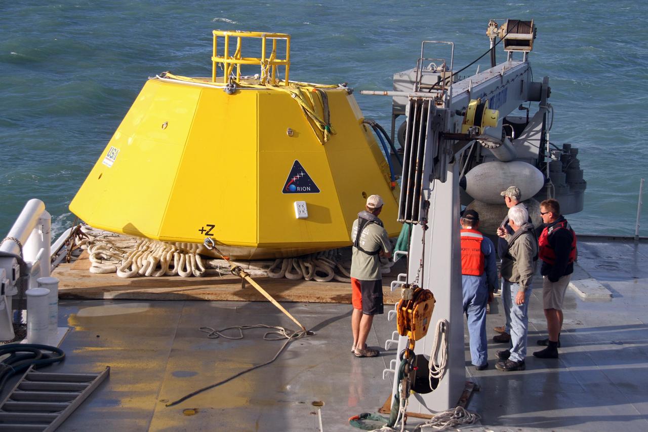 CAPE CANAVERAL, Fla. – An Orion flight test capsule aboard the deck of NASA's Liberty Star ship is moments away from being pulled overboard into the Atlantic Ocean. The Crew Module Recovery Attach Fitting Test (CRAFT) on the capsule, which began at-sea operations Nov. 29, is under way. Multiple attach clips are being evaluated against the current recovery cleat configuration by U.S. Air Force pararescue jumpers (PJs) and a U.S. Navy diver. The 21st Century Ground Systems Program will use data collected from the tests to help develop ground operations support equipment that could be used to recover an uncrewed Orion flight test capsule after splashdown. The Orion Multi-Purpose Crew Vehicle is NASA's next-generation spacecraft being developed for deep space missions to asteroids, moons and other interplanetary destinations throughout the solar system. For more information, visit http://www.nasa.gov/orion. Photo credit: NASA/Cory Huston