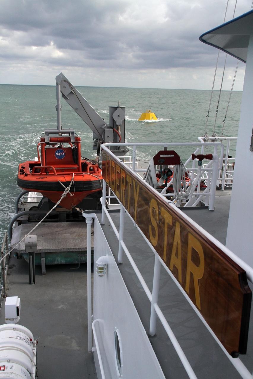 CAPE CANAVERAL, Fla. – Testing is under way on an Orion flight test capsule in the Atlantic Ocean. The tests are being monitored by workers aboard NASA's Liberty Star ship. The Crew Module Recovery Attach Fitting Test (CRAFT) on the capsule, which began at-sea operations Nov. 29, is under way. Multiple attach clips are being evaluated against the current recovery cleat configuration by U.S. Air Force pararescue jumpers (PJs) and a U.S. Navy diver. The 21st Century Ground Systems Program will use data collected from the tests to help develop ground operations support equipment that could be used to recover an uncrewed Orion flight test capsule after splashdown. The Orion Multi-Purpose Crew Vehicle is NASA's next-generation spacecraft being developed for deep space missions to asteroids, moons and other interplanetary destinations throughout the solar system. For more information, visit http://www.nasa.gov/orion. Photo credit: NASA/Cory Huston