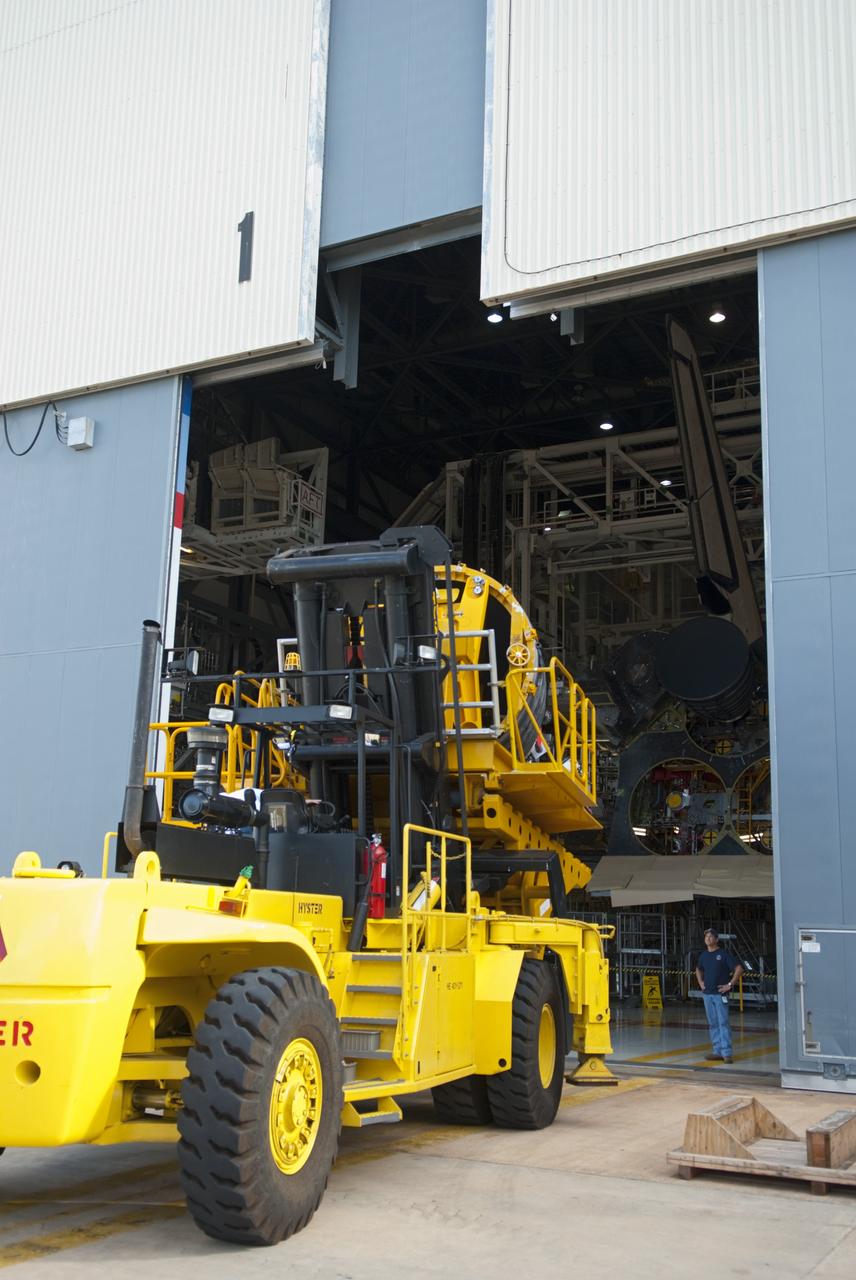 CAPE CANAVERAL, Fla. – A replica shuttle main engine (RSME) rolls through the high bay door of Orbiter Processing Facility-1 at NASA’s Kennedy Space Center in Florida where it will be installed on space shuttle Discovery.  The RSME was built in the Pratt & Whitney Rocketdyne engine shop at Kennedy.    The RSME is one of three that will be installed on Discovery during Space Shuttle Program transition and retirement activities. Discovery is being prepared for display at the Smithsonian’s National Air and Space Museum Steven F. Udvar-Hazy Center in Chantilly, Va. For more information, visit http://www.nasa.gov/shuttle.  Photo credit: NASA/Jim Grossmann