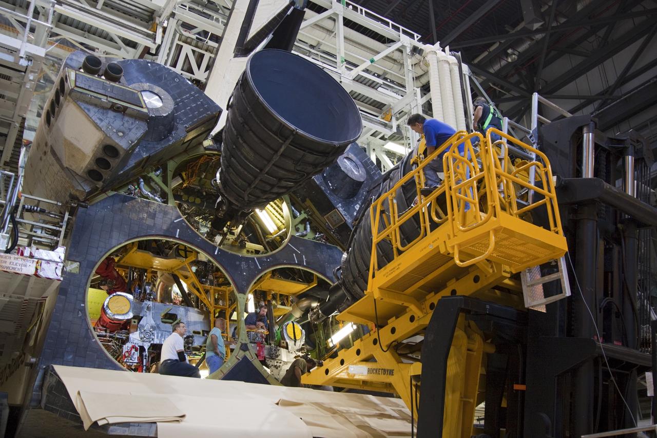 CAPE CANAVERAL, Fla. – Workers in Orbiter Processing Facility-1 at NASA’s Kennedy Space Center in Florida move a replica shuttle main engine (RSME) into position for installation on space shuttle Discovery.    The RSME is one of three that will be installed on Discovery during Space Shuttle Program transition and retirement activities. The replicas are being built in the Pratt & Whitney Rocketdyne engine shop at Kennedy to replace the shuttle engines which will be placed in storage to support NASA's Space Launch System, under development. Discovery is being prepared for display at the Smithsonian’s National Air and Space Museum Steven F. Udvar-Hazy Center in Chantilly, Va. For more information, visit http://www.nasa.gov/shuttle.  Photo credit: NASA/Jim Grossmann