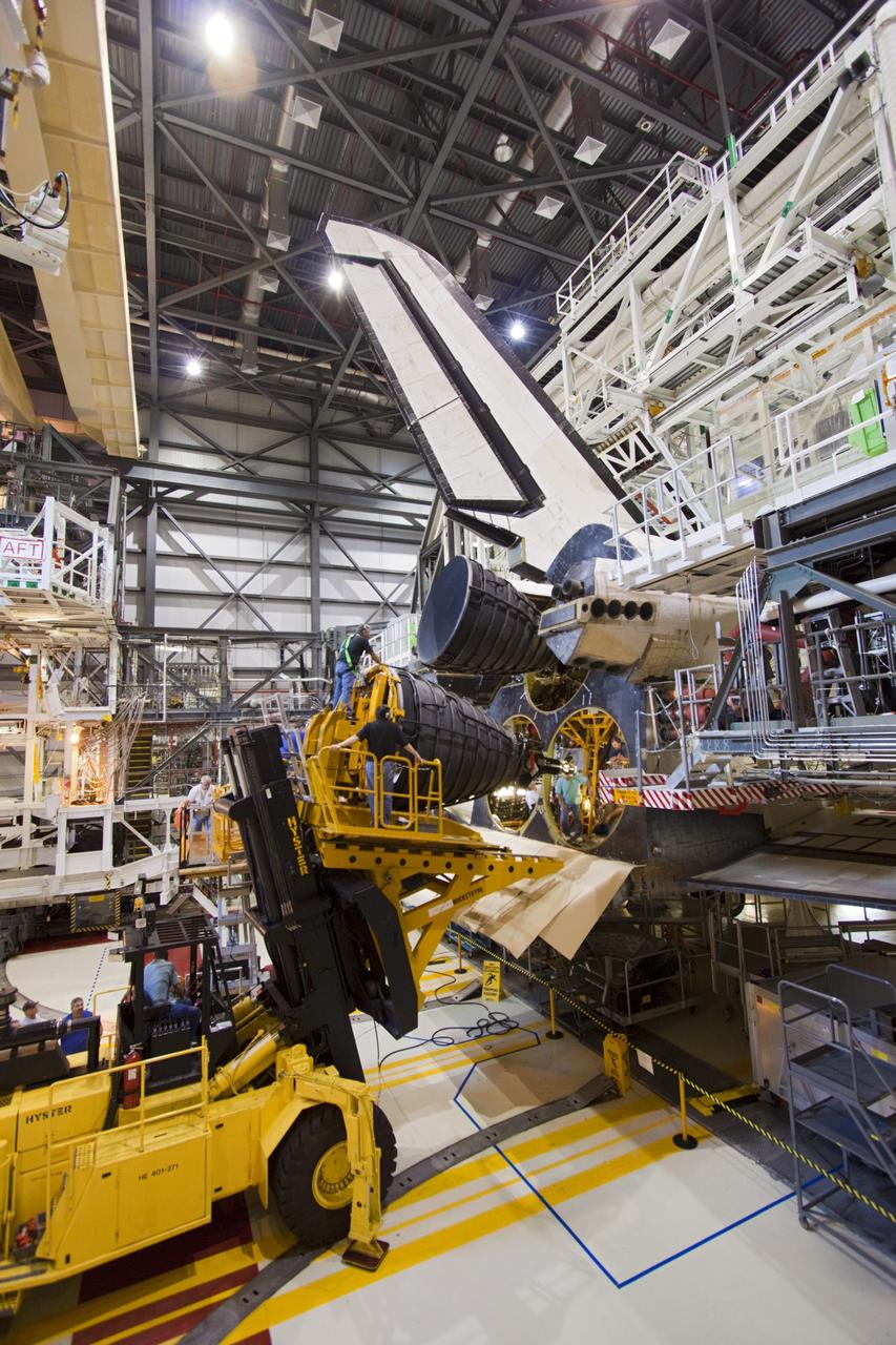 CAPE CANAVERAL, Fla. – A replica shuttle main engine (RSME) is poised for installation on space shuttle Discovery in Orbiter Processing Facility-1 at NASA’s Kennedy Space Center in Florida. The RSME is one of three that will be installed on Discovery during Space Shuttle Program transition and retirement activities. The replicas are being built in the Pratt & Whitney Rocketdyne engine shop at Kennedy to replace the shuttle engines which will be placed in storage to support NASA's Space Launch System, under development. Discovery is being prepared for display at the Smithsonian’s National Air and Space Museum Steven F. Udvar-Hazy Center in Chantilly, Va. For more information, visit http://www.nasa.gov/shuttle. Photo credit: NASA/Jim Grossmann