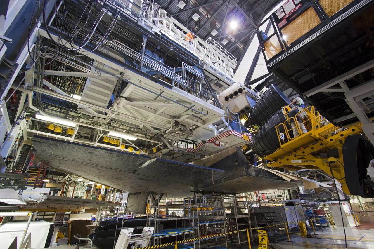 CAPE CANAVERAL, Fla. – In Orbiter Processing Facility-1 at NASA’s Kennedy Space Center in Florida, the third and final replica shuttle main engine (RSME) slides into an engine well of space shuttle Discovery with the aid of a Hyster forklift, a specially designed engine installer.    The RSME is one of three being installed on Discovery during Space Shuttle Program transition and retirement activities. The replicas are built in the Pratt & Whitney Rocketdyne engine shop at Kennedy to replace the shuttle engines which will be placed in storage to support NASA's Space Launch System, under development. Discovery is being prepared for display at the Smithsonian’s National Air and Space Museum Steven F. Udvar-Hazy Center in Chantilly, Va. For more information, visit http://www.nasa.gov/shuttle.  Photo credit: NASA/Jim Grossmann