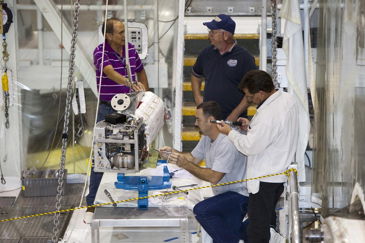 CAPE CANAVERAL, Fla. – Inside Orbiter Processing Facility-1 at NASA’s Kennedy Space Center in Florida, technicians prepare to re-install the three fuel cells in space shuttle Discovery’s mid-body.    The fuel cells were removed and drained of all fluids. The hydrogen and oxygen dewars which feed reactants to the fuel cells remain in Discovery’s mid-body and have been purged with inert gases and vented down. The work is part of the Space Shuttle Program’s transition and retirement processing of shuttle Discovery. Discovery is being prepared for display at the Smithsonian’s National Air and Space Museum, Steven F. Udvar-Hazy Center in Chantilly, Va. For more information, visit http://www.nasa.gov/shuttle.  Photo credit: NASA/Dimitri Gerondidakis