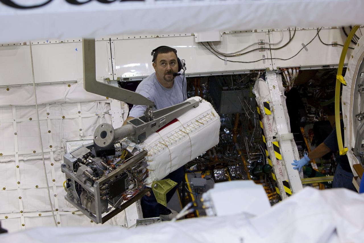 CAPE CANAVERAL, Fla. – Inside Orbiter Processing Facility-1 at NASA’s Kennedy Space Center in Florida, technicians prepare to re-install the three fuel cells in space shuttle Discovery’s mid-body.    The fuel cells were removed and drained of all fluids. The hydrogen and oxygen dewars which feed reactants to the fuel cells remain in Discovery’s mid-body and have been purged with inert gases and vented down. The work is part of the Space Shuttle Program’s transition and retirement processing of shuttle Discovery. Discovery is being prepared for display at the Smithsonian’s National Air and Space Museum, Steven F. Udvar-Hazy Center in Chantilly, Va. For more information, visit http://www.nasa.gov/shuttle.  Photo credit: NASA/Dimitri Gerondidakis