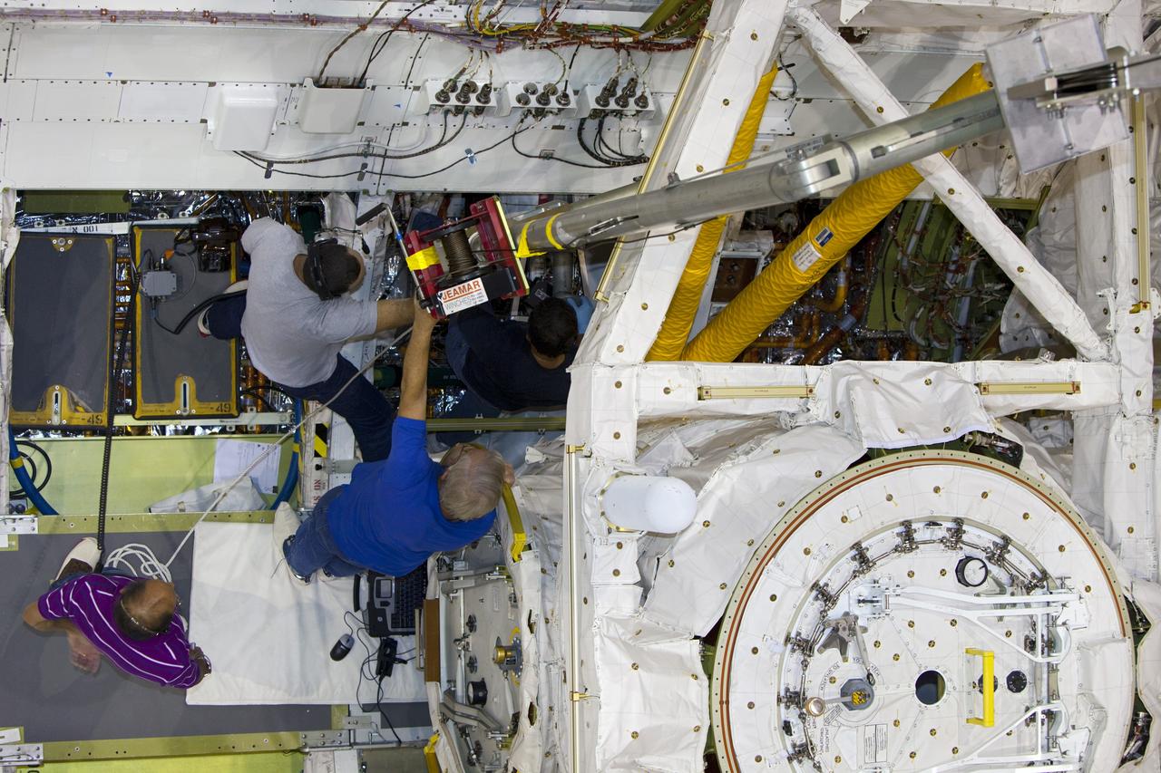CAPE CANAVERAL, Fla. – Inside Orbiter Processing Facility-1 at NASA’s Kennedy Space Center in Florida, technicians re-install the three fuel cells in space shuttle Discovery’s mid-body.    The fuel cells were removed and drained of all fluids. The hydrogen and oxygen dewars which feed reactants to the fuel cells remain in Discovery’s mid-body and have been purged with inert gases and vented down. The work is part of the Space Shuttle Program’s transition and retirement processing of shuttle Discovery. Discovery is being prepared for display at the Smithsonian’s National Air and Space Museum, Steven F. Udvar-Hazy Center in Chantilly, Va. For more information, visit http://www.nasa.gov/shuttle.  Photo credit: NASA/Dimitri Gerondidakis