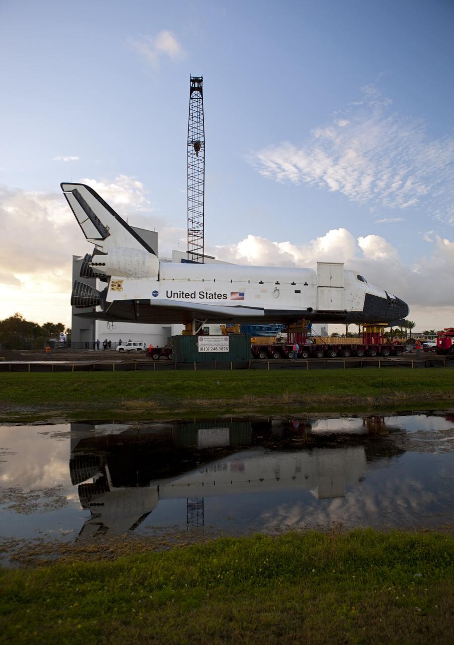 CAPE CANAVERAL, Fla. – A reflection of the high-fidelity space shuttle model on display at the NASA Kennedy Space Center Visitor Complex in Florida is captured in the water near the visitor complex as preparations are made to move it to NASA Kennedy Space Center's Launch Complex 39 turn basin.   The shuttle was part of a display at the visitor complex that also included an external tank and two solid rocket boosters that were used to show visitors the size of actual space shuttle components. The full-scale shuttle model is being transferred from Kennedy to Space Center Houston, NASA Johnson Space Center's visitor center. The model will stay at the turn basin for a few months until it is ready to be transported to Texas via barge. The move also helps clear the way for the Kennedy Space Center Visitor Complex to begin construction of a new facility next year to display space shuttle Atlantis in 2013.  For more information about Space Center Houston, visit http://www.spacecenter.org.  Photo credit: NASA/Dimitri Gerondidakis