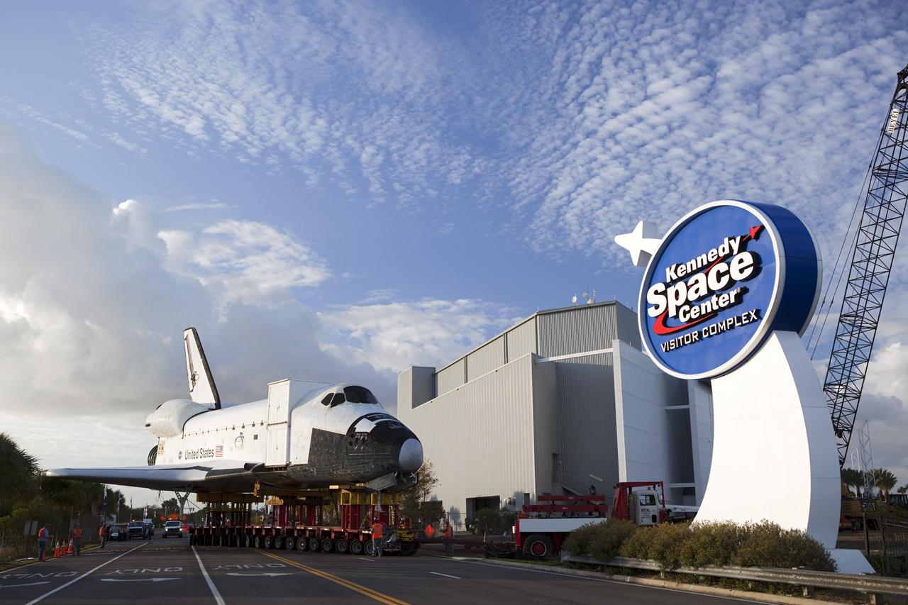 CAPE CANAVERAL, Fla. – The transporter carrying the high-fidelity space shuttle model on display at the NASA Kennedy Space Center Visitor Complex in Florida rolls onto the roadway at the visitor complex to begin its move to NASA Kennedy Space Center's Launch Complex 39 turn basin.  The shuttle was part of a display at the visitor complex that also included an external tank and two solid rocket boosters that were used to show visitors the size of actual space shuttle components. The full-scale shuttle model is being transferred from Kennedy to Space Center Houston, NASA Johnson Space Center's visitor center. The model will stay at the turn basin for a few months until it is ready to be transported to Texas via barge. The move also helps clear the way for the Kennedy Space Center Visitor Complex to begin construction of a new facility next year to display space shuttle Atlantis in 2013.  For more information about Space Center Houston, visit http://www.spacecenter.org.  Photo credit: NASA/Dimitri Gerondidakis