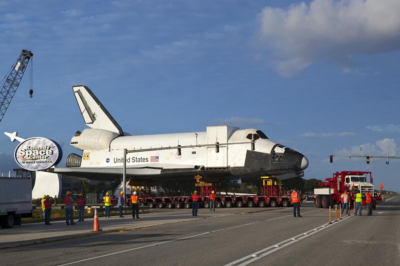 CAPE CANAVERAL, Fla. – The transporter carrying the high-fidelity space shuttle model that was on display at the NASA Kennedy Space Center Visitor Complex in Florida rolls onto NASA Causeway at the visitor complex on its way to NASA Kennedy Space Center's Launch Complex 39 turn basin.  The shuttle was part of a display at the visitor complex that also included an external tank and two solid rocket boosters that were used to show visitors the size of actual space shuttle components. The full-scale shuttle model is being transferred from Kennedy to Space Center Houston, NASA Johnson Space Center's visitor center. The model will stay at the turn basin for a few months until it is ready to be transported to Texas via barge. The move also helps clear the way for the Kennedy Space Center Visitor Complex to begin construction of a new facility next year to display space shuttle Atlantis in 2013.  For more information about Space Center Houston, visit http://www.spacecenter.org.  Photo credit: NASA/Dimitri Gerondidakis