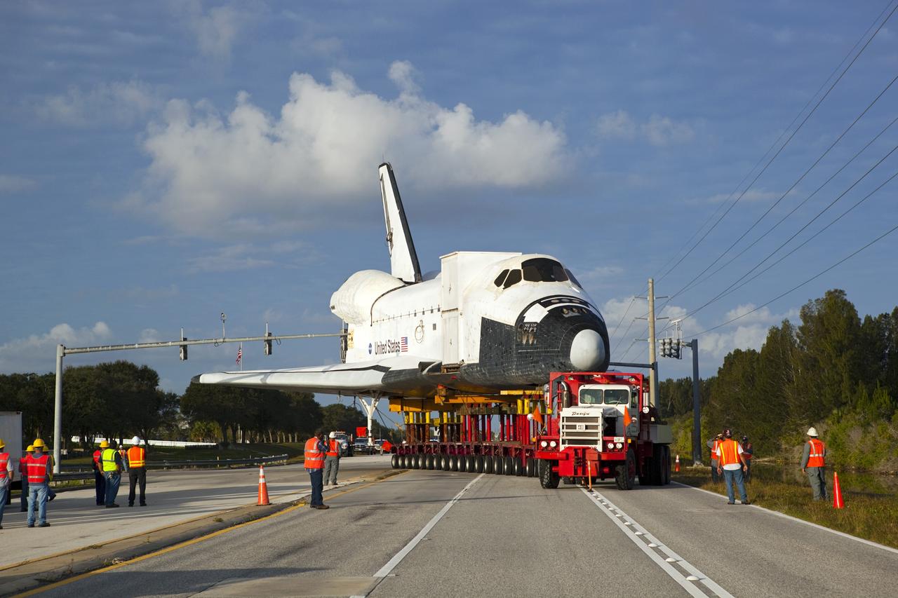 CAPE CANAVERAL, Fla. – The transporter carrying the high-fidelity space shuttle model that was on display at the NASA Kennedy Space Center Visitor Complex in Florida makes a wide turn into the right-hand lane of the NASA Causeway as it leaves the visitor complex on its way to NASA Kennedy Space Center's Launch Complex 39 turn basin.  It is standard procedure for large payloads and equipment to travel against the normal flow of traffic under the supervision of a move crew when being transported on or off center property.  The shuttle was part of a display at the visitor complex that also included an external tank and two solid rocket boosters that were used to show visitors the size of actual space shuttle components. The full-scale shuttle model is being transferred from Kennedy to Space Center Houston, NASA Johnson Space Center's visitor center. The model will stay at the turn basin for a few months until it is ready to be transported to Texas via barge. The move also helps clear the way for the Kennedy Space Center Visitor Complex to begin construction of a new facility next year to display space shuttle Atlantis in 2013.  For more information about Space Center Houston, visit http://www.spacecenter.org.  Photo credit: NASA/Dimitri Gerondidakis