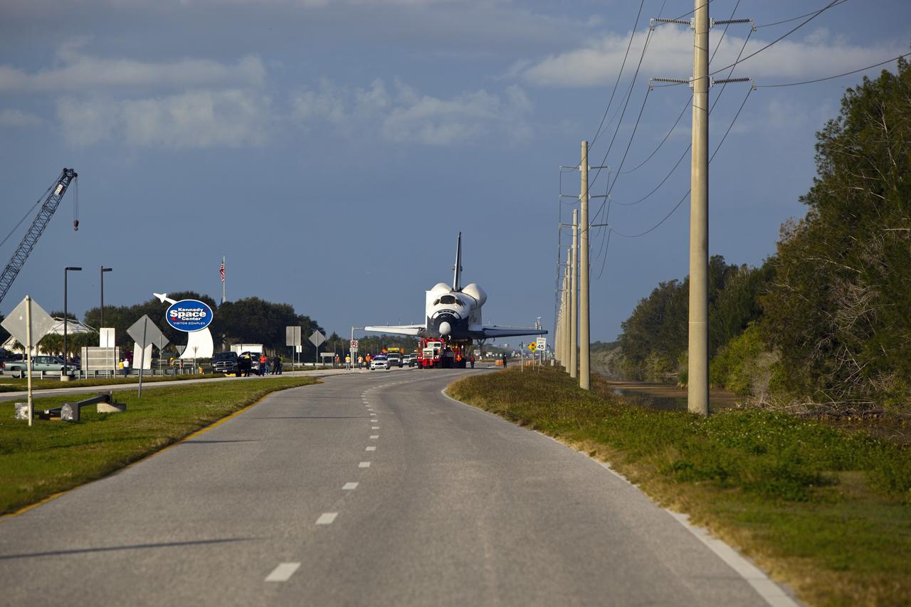 CAPE CANAVERAL, Fla. – A transporter carrying the high-fidelity space shuttle model that was on display at the NASA Kennedy Space Center Visitor Complex in Florida rolls along the NASA Causeway as it leaves the visitor complex on its way to NASA Kennedy Space Center's Launch Complex 39 turn basin.  It is standard procedure for large payloads and equipment to travel against the normal flow of traffic under the supervision of a move crew when being transported on or off center property.  The shuttle was part of a display at the visitor complex that also included an external tank and two solid rocket boosters that were used to show visitors the size of actual space shuttle components. The full-scale shuttle model is being transferred from Kennedy to Space Center Houston, NASA Johnson Space Center's visitor center. The model will stay at the turn basin for a few months until it is ready to be transported to Texas via barge. The move also helps clear the way for the Kennedy Space Center Visitor Complex to begin construction of a new facility next year to display space shuttle Atlantis in 2013.  For more information about Space Center Houston, visit http://www.spacecenter.org.  Photo credit: NASA/Dimitri Gerondidakis