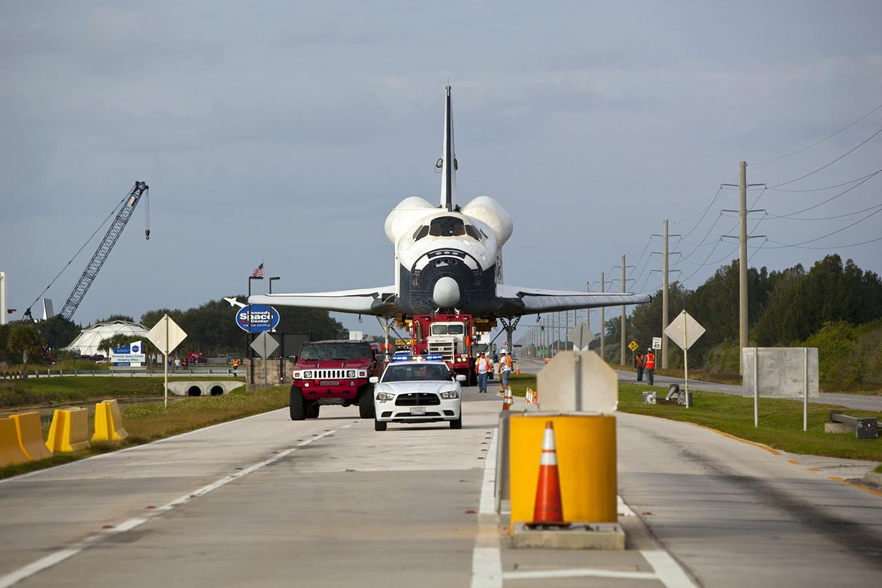 CAPE CANAVERAL, Fla. – A transporter carrying the high-fidelity space shuttle model that was on display at the NASA Kennedy Space Center Visitor Complex in Florida rolls away from the visitor complex on its way to NASA Kennedy Space Center's Launch Complex 39 turn basin.  The shuttle was part of a display at the visitor complex that also included an external tank and two solid rocket boosters that were used to show visitors the size of actual space shuttle components. The full-scale shuttle model is being transferred from Kennedy to Space Center Houston, NASA Johnson Space Center's visitor center. The model will stay at the turn basin for a few months until it is ready to be transported to Texas via barge. The move also helps clear the way for the Kennedy Space Center Visitor Complex to begin construction of a new facility next year to display space shuttle Atlantis in 2013.  For more information about Space Center Houston, visit http://www.spacecenter.org.  Photo credit: NASA/Dimitri Gerondidakis