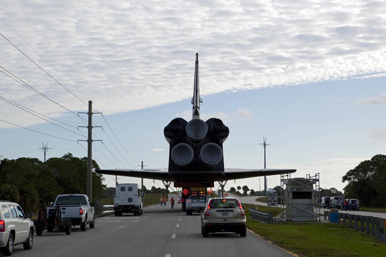 CAPE CANAVERAL, Fla. – The high-fidelity space shuttle model that was on display at the NASA Kennedy Space Center Visitor Complex in Florida nears the intersection of NASA Causeway and Kennedy Parkway.  It is standard procedure for large payloads and equipment to travel against the normal flow of traffic under the supervision of a move crew when being transported on or off center property. The model is being moved from the visitor complex to NASA Kennedy Space Center's Launch Complex 39 turn basin.  The shuttle was part of a display at the visitor complex that also included an external tank and two solid rocket boosters that were used to show visitors the size of actual space shuttle components. The full-scale shuttle model is being transferred from Kennedy to Space Center Houston, NASA Johnson Space Center's visitor center. The model will stay at the turn basin for a few months until it is ready to be transported to Texas via barge. The move also helps clear the way for the Kennedy Space Center Visitor Complex to begin construction of a new facility next year to display space shuttle Atlantis in 2013.  For more information about Space Center Houston, visit http://www.spacecenter.org.  Photo credit: NASA/Dimitri Gerondidakis