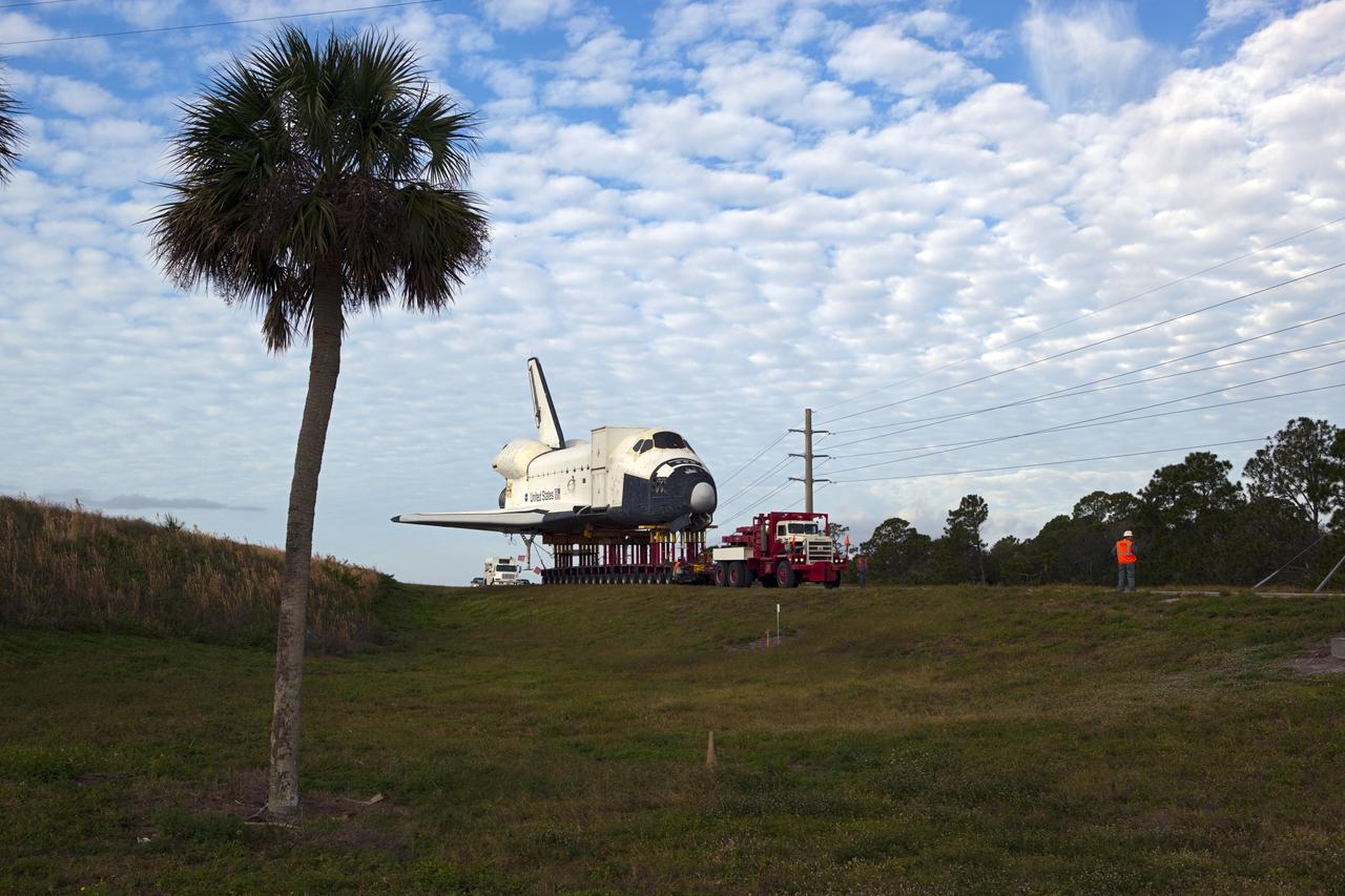 CAPE CANAVERAL, Fla. – The high-fidelity space shuttle model that was on display at the NASA Kennedy Space Center Visitor Complex in Florida negotiates the on-ramp at the intersection of NASA Causeway and Kennedy Parkway to gain entrance to the northbound roadways on the center.  It is standard procedure for large payloads and equipment to travel against the normal flow of traffic under the supervision of a move crew when being transported on or off center property. The model is being moved from the visitor complex to NASA Kennedy Space Center's Launch Complex 39 turn basin.  The shuttle was part of a display at the visitor complex that also included an external tank and two solid rocket boosters that were used to show visitors the size of actual space shuttle components. The full-scale shuttle model is being transferred from Kennedy to Space Center Houston, NASA Johnson Space Center's visitor center. The model will stay at the turn basin for a few months until it is ready to be transported to Texas via barge. The move also helps clear the way for the Kennedy Space Center Visitor Complex to begin construction of a new facility next year to display space shuttle Atlantis in 2013.  For more information about Space Center Houston, visit http://www.spacecenter.org.  Photo credit: NASA/Dimitri Gerondidakis