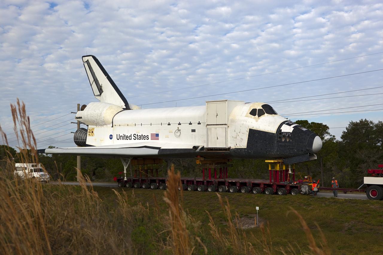 CAPE CANAVERAL, Fla. – The high-fidelity space shuttle model that was on display at the NASA Kennedy Space Center Visitor Complex in Florida moves along the on-ramp from NASA Causeway to Kennedy Parkway to gain entrance to the northbound roadways on the center.  It is standard procedure for large payloads and equipment to travel against the normal flow of traffic under the supervision of a move crew when being transported on or off center property. The model is being moved from the visitor complex to NASA Kennedy Space Center's Launch Complex 39 turn basin.  The shuttle was part of a display at the visitor complex that also included an external tank and two solid rocket boosters that were used to show visitors the size of actual space shuttle components. The full-scale shuttle model is being transferred from Kennedy to Space Center Houston, NASA Johnson Space Center's visitor center. The model will stay at the turn basin for a few months until it is ready to be transported to Texas via barge. The move also helps clear the way for the Kennedy Space Center Visitor Complex to begin construction of a new facility next year to display space shuttle Atlantis in 2013.  For more information about Space Center Houston, visit http://www.spacecenter.org.  Photo credit: NASA/Dimitri Gerondidakis