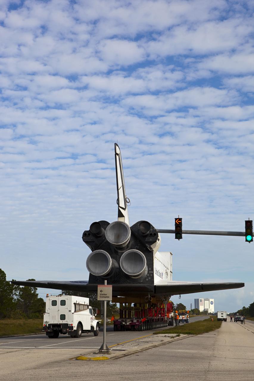 CAPE CANAVERAL, Fla. – The high-fidelity space shuttle model that was on display at the NASA Kennedy Space Center Visitor Complex in Florida moves past the traffic signals onto Kennedy Parkway as it travels northbound toward NASA Kennedy Space Center's Launch Complex 39 turn basin.  It is standard procedure for large payloads and equipment to travel against the normal flow of traffic under the supervision of a move crew when being transported on or off center property.  The shuttle was part of a display at the visitor complex that also included an external tank and two solid rocket boosters that were used to show visitors the size of actual space shuttle components. The full-scale shuttle model is being transferred from Kennedy to Space Center Houston, NASA Johnson Space Center's visitor center. The model will stay at the turn basin for a few months until it is ready to be transported to Texas via barge. The move also helps clear the way for the Kennedy Space Center Visitor Complex to begin construction of a new facility next year to display space shuttle Atlantis in 2013.  For more information about Space Center Houston, visit http://www.spacecenter.org.  Photo credit: NASA/Dimitri Gerondidakis