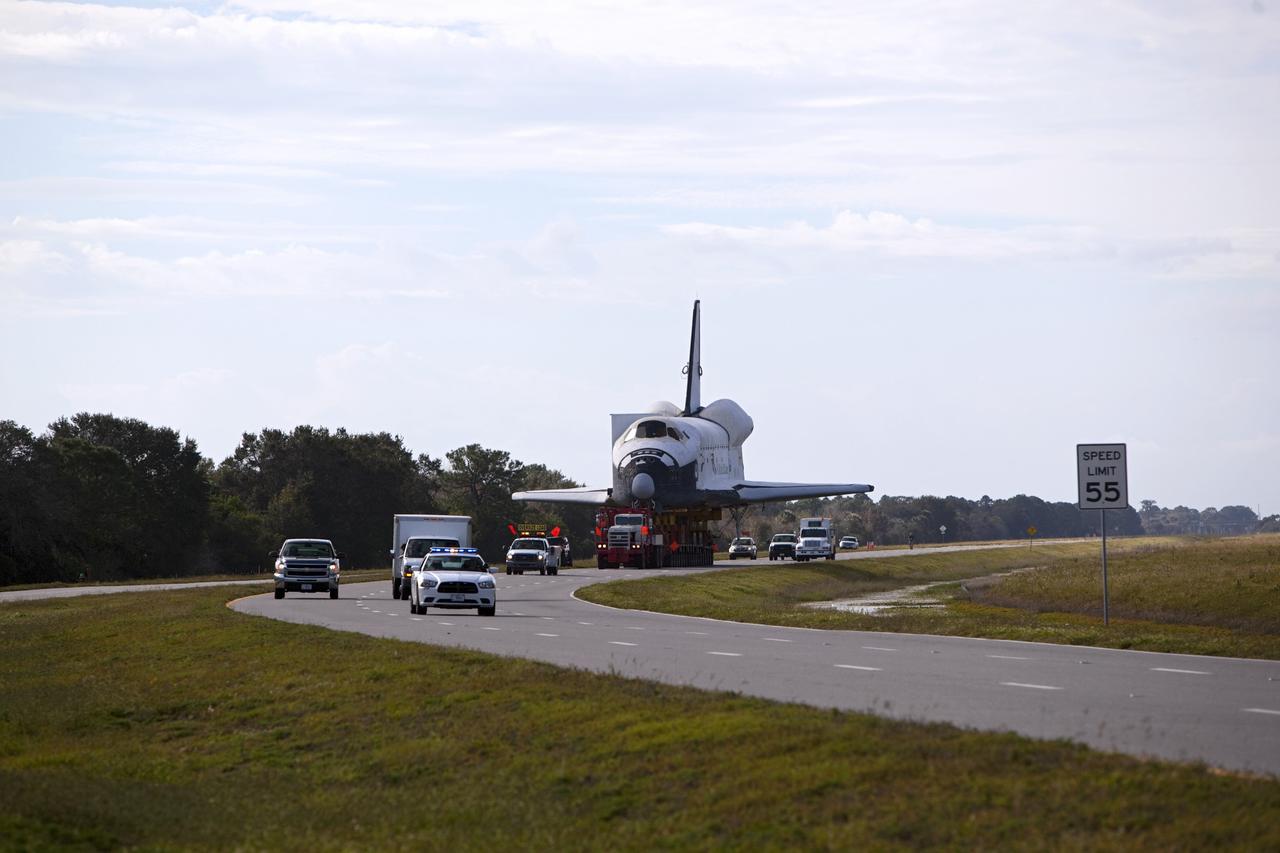 CAPE CANAVERAL, Fla. – The high-fidelity space shuttle model that was on display at the NASA Kennedy Space Center Visitor Complex in Florida travels northbound along Kennedy Parkway toward NASA Kennedy Space Center's Launch Complex 39 turn basin.  It is standard procedure for large payloads and equipment to travel against the normal flow of traffic under the supervision of a move crew when being transported on or off center property.  The shuttle was part of a display at the visitor complex that also included an external tank and two solid rocket boosters that were used to show visitors the size of actual space shuttle components. The full-scale shuttle model is being transferred from Kennedy to Space Center Houston, NASA Johnson Space Center's visitor center. The model will stay at the turn basin for a few months until it is ready to be transported to Texas via barge. The move also helps clear the way for the Kennedy Space Center Visitor Complex to begin construction of a new facility next year to display space shuttle Atlantis in 2013.  For more information about Space Center Houston, visit http://www.spacecenter.org.  Photo credit: NASA/Dimitri Gerondidakis