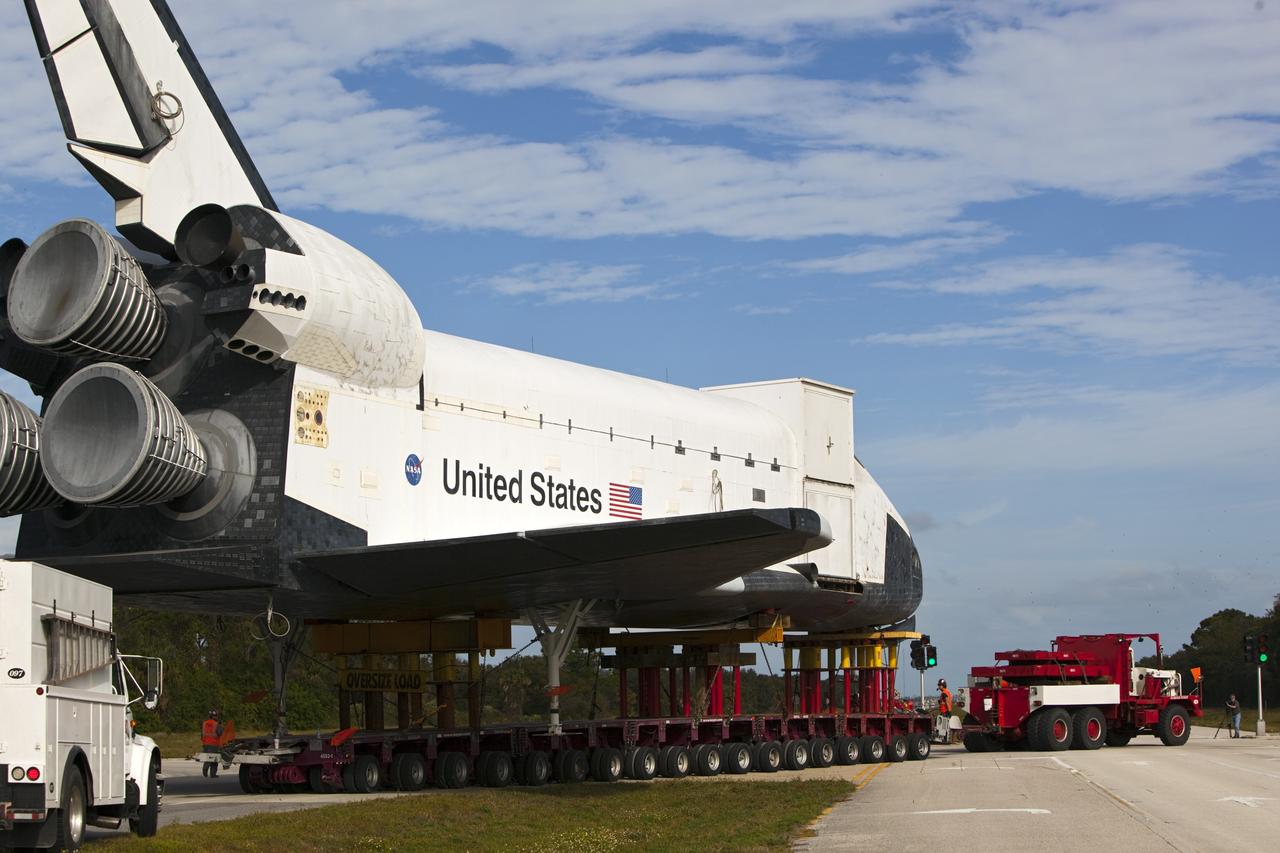 CAPE CANAVERAL, Fla. – The high-fidelity space shuttle model that was on display at the NASA Kennedy Space Center Visitor Complex in Florida negotiates the turn from Kennedy Parkway onto Schwartz Road on its way toward NASA Kennedy Space Center's Launch Complex 39 turn basin.  It is standard procedure for large payloads and equipment to travel against the normal flow of traffic under the supervision of a move crew when being transported on or off center property.  The shuttle was part of a display at the visitor complex that also included an external tank and two solid rocket boosters that were used to show visitors the size of actual space shuttle components. The full-scale shuttle model is being transferred from Kennedy to Space Center Houston, NASA Johnson Space Center's visitor center. The model will stay at the turn basin for a few months until it is ready to be transported to Texas via barge. The move also helps clear the way for the Kennedy Space Center Visitor Complex to begin construction of a new facility next year to display space shuttle Atlantis in 2013.  For more information about Space Center Houston, visit http://www.spacecenter.org.  Photo credit: NASA/Dimitri Gerondidakis