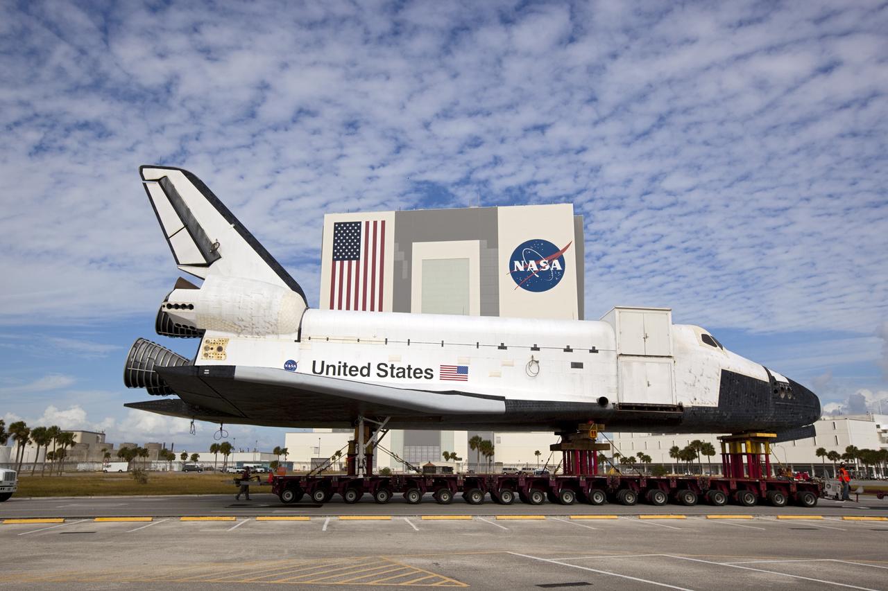 CAPE CANAVERAL, Fla. – The high-fidelity space shuttle model which was on display at the NASA Kennedy Space Center Visitor Complex in Florida passes in front of the 525-foot-tall Vehicle Assembly Building as it makes its way to Kennedy's Launch Complex 39 turn basin.     The shuttle was part of a display at the visitor complex that also included an external tank and two solid rocket boosters that were used to show visitors the size of actual space shuttle components. The full-scale shuttle model is being transferred from Kennedy to Space Center Houston, NASA Johnson Space Center's visitor center. The model will stay at the turn basin for a few months until it is ready to be transported to Texas via barge. The move also helps clear the way for the Kennedy Space Center Visitor Complex to begin construction of a new facility next year to display space shuttle Atlantis in 2013.  For more information about Space Center Houston, visit http://www.spacecenter.org.  Photo credit: NASA/Dimitri Gerondidakis