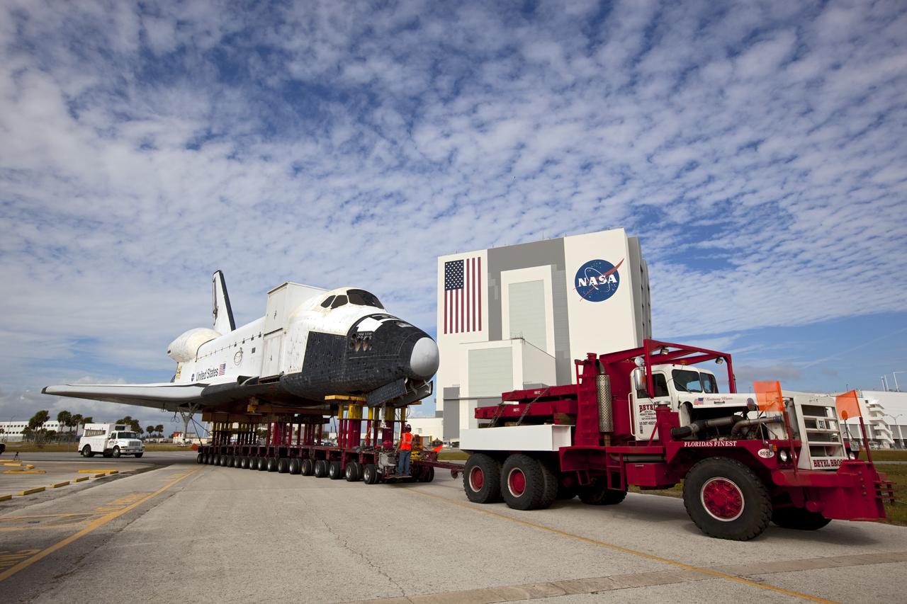 CAPE CANAVERAL, Fla. – The high-fidelity space shuttle model which was on display at the NASA Kennedy Space Center Visitor Complex in Florida turns into the parking lot leading to Kennedy's Launch Complex 39 turn basin.  Behind it is the 525-foot-tall Vehicle Assembly Building.     The shuttle was part of a display at the visitor complex that also included an external tank and two solid rocket boosters that were used to show visitors the size of actual space shuttle components. The full-scale shuttle model is being transferred from Kennedy to Space Center Houston, NASA Johnson Space Center's visitor center. The model will stay at the turn basin for a few months until it is ready to be transported to Texas via barge. The move also helps clear the way for the Kennedy Space Center Visitor Complex to begin construction of a new facility next year to display space shuttle Atlantis in 2013.  For more information about Space Center Houston, visit http://www.spacecenter.org.  Photo credit: NASA/Dimitri Gerondidakis