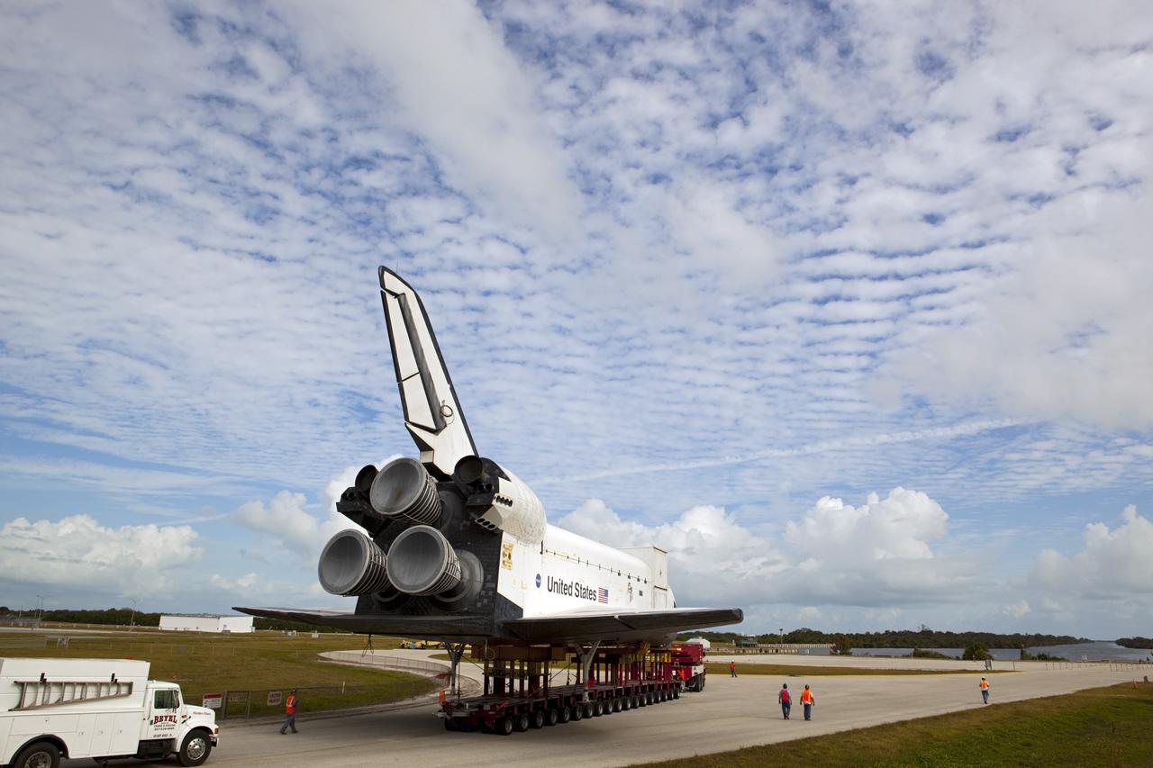 CAPE CANAVERAL, Fla. – The high-fidelity space shuttle model which was on display at the NASA Kennedy Space Center Visitor Complex in Florida approaches its destination, Kennedy's Launch Complex 39 turn basin, in the distance.     The shuttle was part of a display at the visitor complex that also included an external tank and two solid rocket boosters that were used to show visitors the size of actual space shuttle components. The full-scale shuttle model is being transferred from Kennedy to Space Center Houston, NASA Johnson Space Center's visitor center. The model will stay at the turn basin for a few months until it is ready to be transported to Texas via barge. The move also helps clear the way for the Kennedy Space Center Visitor Complex to begin construction of a new facility next year to display space shuttle Atlantis in 2013.  For more information about Space Center Houston, visit http://www.spacecenter.org.  Photo credit: NASA/Dimitri Gerondidakis