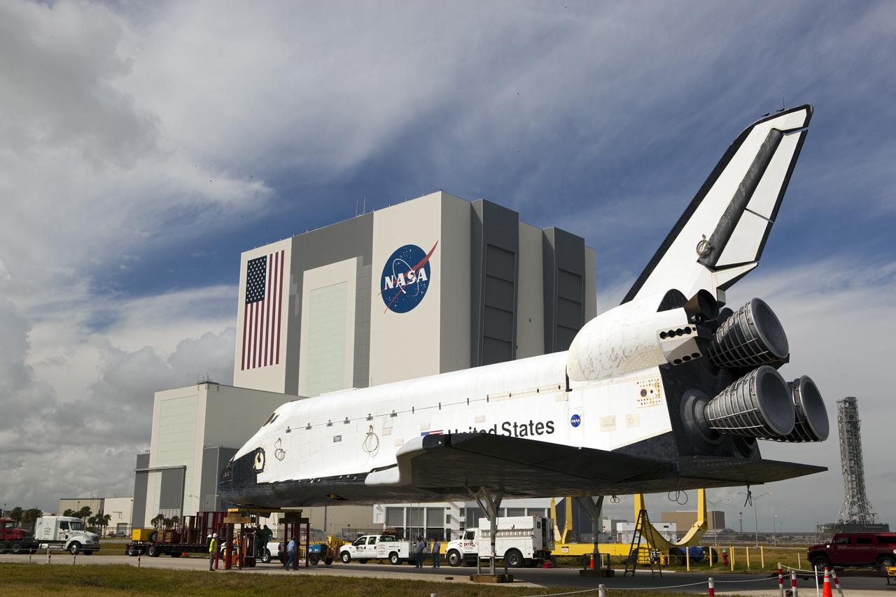 CAPE CANAVERAL, Fla. – Pedestals support the high-fidelity space shuttle model which was on display at the NASA Kennedy Space Center Visitor Complex in Florida following its delivery to Kennedy's Launch Complex 39 turn basin.  Behind it, the Vehicle Assembly Building towers 525 feet in the air.     The shuttle was part of a display at the visitor complex that also included an external tank and two solid rocket boosters that were used to show visitors the size of actual space shuttle components. The full-scale shuttle model is being transferred from Kennedy to Space Center Houston, NASA Johnson Space Center's visitor center. The model will stay at the turn basin for a few months until it is ready to be transported to Texas via barge. The move also helps clear the way for the Kennedy Space Center Visitor Complex to begin construction of a new facility next year to display space shuttle Atlantis in 2013.  For more information about Space Center Houston, visit http://www.spacecenter.org.  Photo credit: NASA/Dimitri Gerondidakis