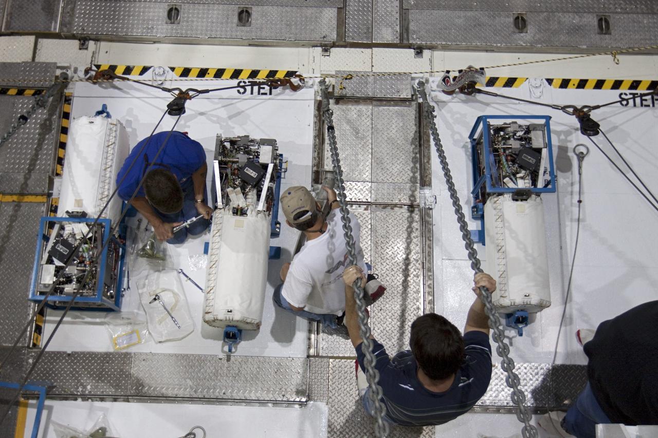 CAPE CANAVERAL, Fla. – Inside Orbiter Processing Facility-2 at NASA’s Kennedy Space Center in Florida, technicians secure space shuttle Atlantis’ three fuel cells to special platforms.    The fuel cells will be drained of all fluids. The hydrogen and oxygen dewars which feed reactants to the fuel cells remain in Atlantis’ mid-body and will be purged with inert gases and vented down. The work is part of the Space Shuttle Program’s transition and retirement processing of shuttle Atlantis. The orbiter is being prepared for display at the Kennedy Space Center Visitor Complex.  Photo credit: NASA/Kim Shiflett