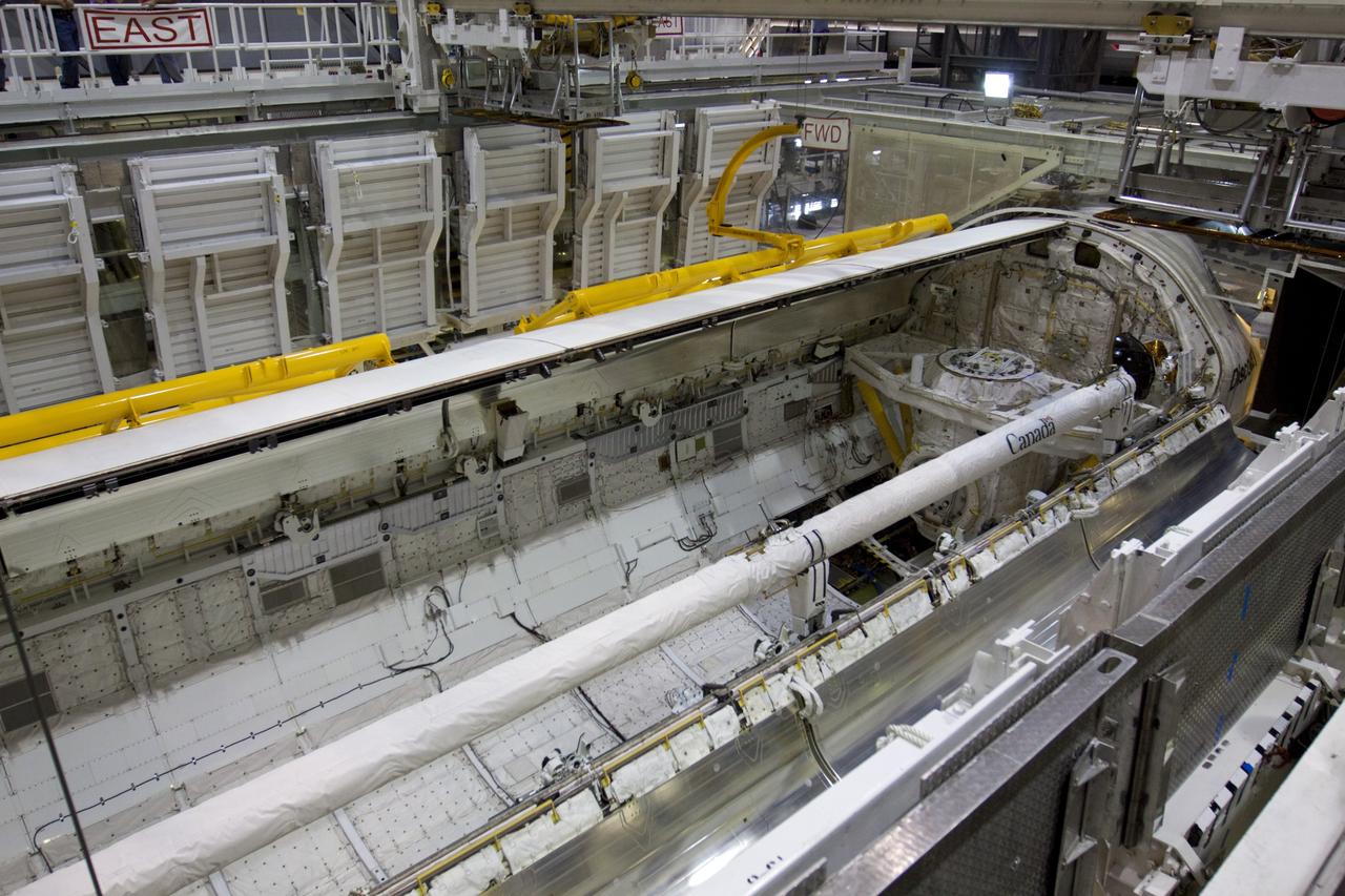 CAPE CANAVERAL, Fla. – In Orbiter Processing Facility-1 at NASA's Kennedy Space Center in Florida, space shuttle Discovery’s payload bay doors swing shut one at a time with the aid of yellow-painted strongbacks, hardware used to support and operate the doors when the shuttle is not in space.  Discovery's payload bay doors are being closed for the final time during Space Shuttle Program transition and retirement activities.    Following the door closure, the vehicle will be powered down for the last time.  Discovery is being prepared for public display at the Smithsonian’s National Air and Space Museum Steven F. Udvar-Hazy Center in Chantilly, Va., in 2012.  For more information, visit http://www.nasa.gov/shuttle.  Photo credit: NASA/Kim Shiflett