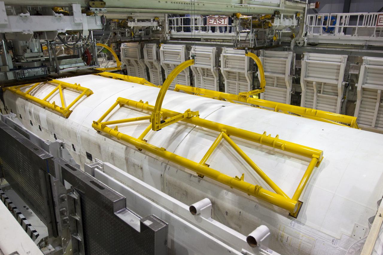 CAPE CANAVERAL, Fla. – In Orbiter Processing Facility-1 at NASA's Kennedy Space Center in Florida, yellow-painted strongbacks complete the task of closing space shuttle Discovery’s payload bay doors for the final time during Space Shuttle Program transition and retirement activities. Strongbacks are used to support and operate the doors when the shuttle is not in space. Following the door closure, the vehicle will be powered down for the last time. Discovery is being prepared for public display at the Smithsonian’s National Air and Space Museum Steven F. Udvar-Hazy Center in Chantilly, Va., in 2012. For more information, visit http://www.nasa.gov/shuttle. Photo credit: NASA/Kim Shiflett