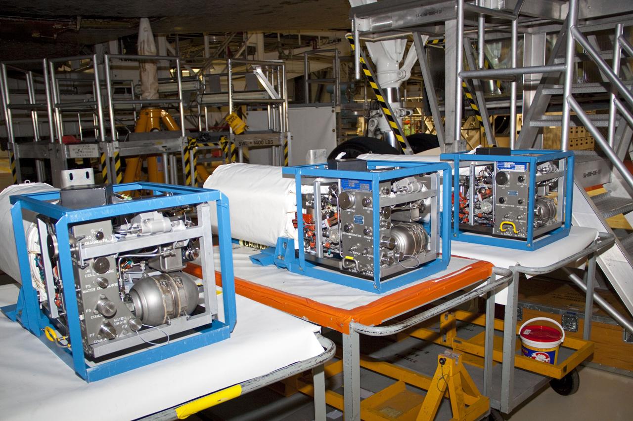 CAPE CANAVERAL, Fla. --Three fuel cells recently removed from space shuttle Atlantis stand on tables in Orbiter Processing Facility-2 at NASA's Kennedy Space Center in Florida. The fuel cells produced electricity for shuttles in space by combining liquid oxygen and liquid hydrogen. They were removed as part of the ongoing work to prepare the shuttles for public display. The shuttle is being prepared for display at the Kennedy Space Center Visitor Complex. Photo credit: NASA/Jim Grossmann