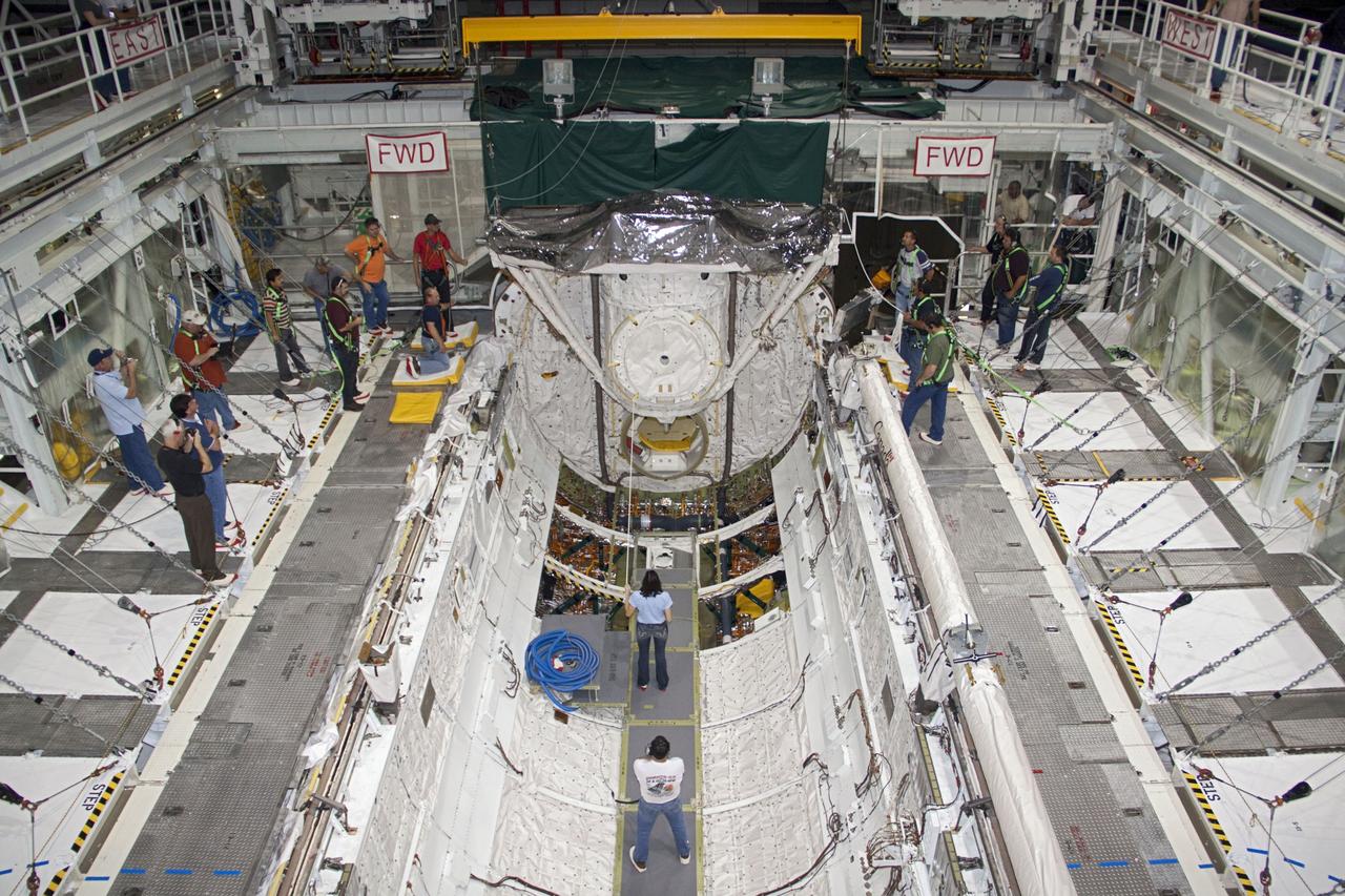 CAPE CANAVERAL, Fla. -- A crane lifts the airlock from the cargo bay of space shuttle Atlantis in Orbiter Processing Facility-2 at NASA's Kennedy Space Center in Florida. The airlock was the connecting point between the shuttle and International Space Station. It was removed as part of the ongoing work to prepare the shuttles for public display. The shuttle is being prepared for display at the Kennedy Space Center Visitor Complex. Photo credit: NASA/Jim Grossmann