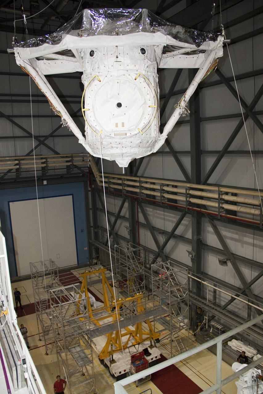 CAPE CANAVERAL, Fla. – A crane lifts the airlock from the cargo bay of space shuttle Atlantis in Orbiter Processing Facility-2 at NASA's Kennedy Space Center in Florida. The airlock was the connecting point between the shuttle and International Space Station. It was removed as part of the ongoing work to prepare the shuttles for public display. The shuttle is being prepared for display at the Kennedy Space Center Visitor Complex. Photo credit: NASA/Jim Grossmann