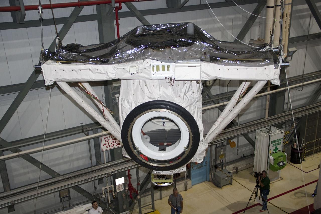 CAPE CANAVERAL, Fla. – A crane lifts the airlock from the cargo bay of space shuttle Atlantis in Orbiter Processing Facility-2 at NASA's Kennedy Space Center in Florida. The airlock was the connecting point between the shuttle and International Space Station. It was removed as part of the ongoing work to prepare the shuttles for public display. The shuttle is being prepared for display at the Kennedy Space Center Visitor Complex. Photo credit: NASA/Jim Grossmann