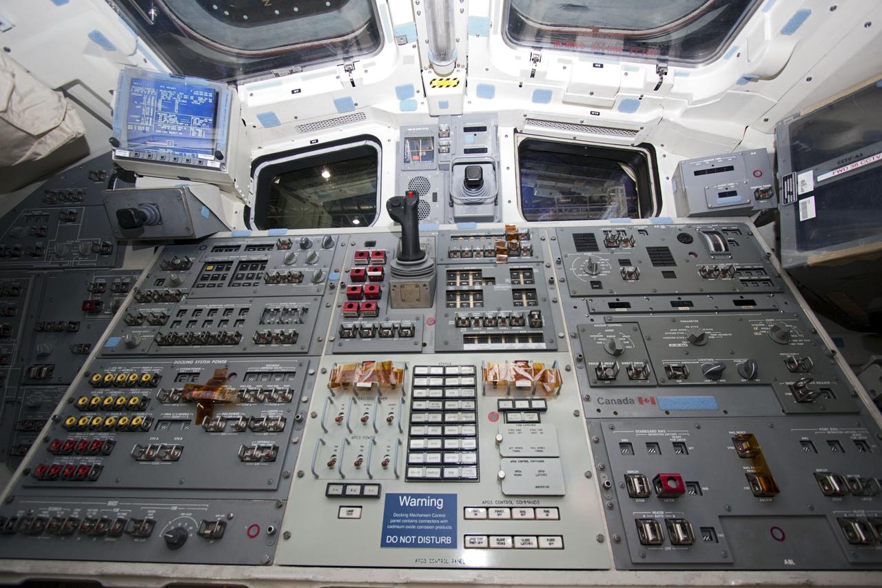 CAPE CANAVERAL, Fla. – In Orbiter Processing Facility-2 at NASA's Kennedy Space Center in Florida, the controller used during docking to the airlock of space shuttle Atlantis stands among the switches filling the control panel on the flight deck. The flight deck is illuminated one last time as preparations are made for the shuttle's final power down during Space Shuttle Program transition and retirement activities. Atlantis is being prepared for public display in 2013 at the Kennedy Space Center Visitor Complex.  For more information, visit http://www.nasa.gov/shuttle.  Photo credit: NASA/Jim Grossmann
