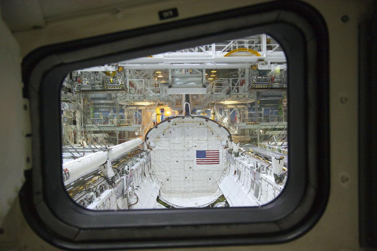 CAPE CANAVERAL, Fla. – In Orbiter Processing Facility-2 at NASA's Kennedy Space Center in Florida, a view of space shuttle Atlantis' payload bay is captured through the window of the flight deck. In the payload bay, at left, is the robotic arm of the shuttle's remote manipulator system (RMS). Preparations are under way for the shuttle's final power down during Space Shuttle Program transition and retirement activities. Atlantis is being prepared for public display in 2013 at the Kennedy Space Center Visitor Complex.  For more information, visit http://www.nasa.gov/shuttle.  Photo credit: NASA/Jim Grossmann