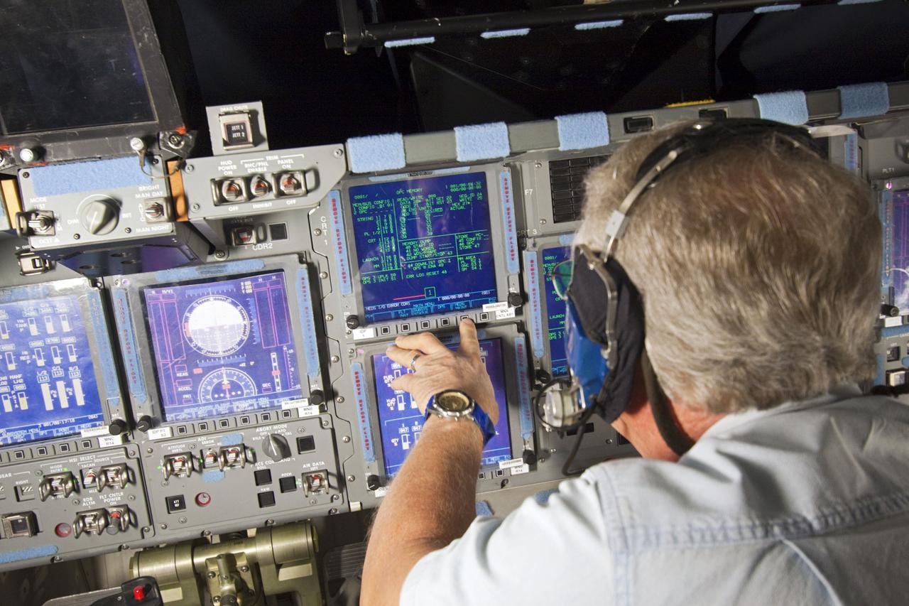 CAPE CANAVERAL, Fla. – In Orbiter Processing Facility-2 at NASA's Kennedy Space Center in Florida, a space shuttle technician reads data displayed on space shuttle Atlantis' glass cockpit during preparations to power down Atlantis for the final time during Space Shuttle Program transition and retirement activities. Atlantis is being prepared for public display in 2013 at the Kennedy Space Center Visitor Complex.  For more information, visit http://www.nasa.gov/shuttle.  Photo credit: NASA/Jim Grossmann