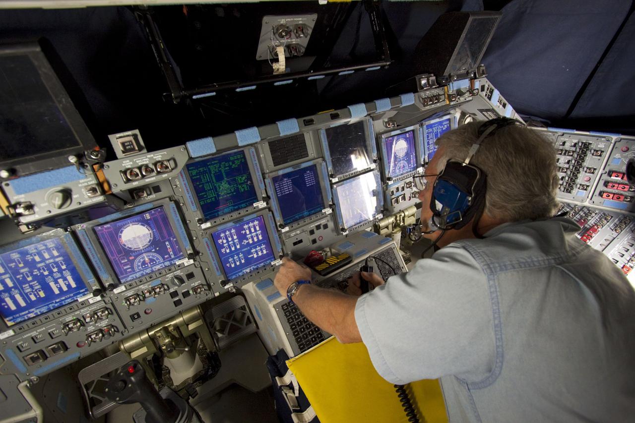 CAPE CANAVERAL, Fla. – In Orbiter Processing Facility-2 at NASA's Kennedy Space Center in Florida, a space shuttle technician monitors data displayed on space shuttle Atlantis' glass cockpit during preparations to power down Atlantis for the final time during Space Shuttle Program transition and retirement activities. Atlantis is being prepared for public display in 2013 at the Kennedy Space Center Visitor Complex.  For more information, visit http://www.nasa.gov/shuttle.  Photo credit: NASA/Jim Grossmann