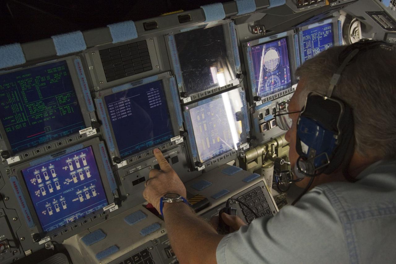 CAPE CANAVERAL, Fla. – In Orbiter Processing Facility-2 at NASA's Kennedy Space Center in Florida, a space shuttle technician monitors data displayed on space shuttle Atlantis' glass cockpit during preparations to power down Atlantis for the final time during Space Shuttle Program transition and retirement activities. Atlantis is being prepared for public display in 2013 at the Kennedy Space Center Visitor Complex.  For more information, visit http://www.nasa.gov/shuttle.  Photo credit: NASA/Jim Grossmann