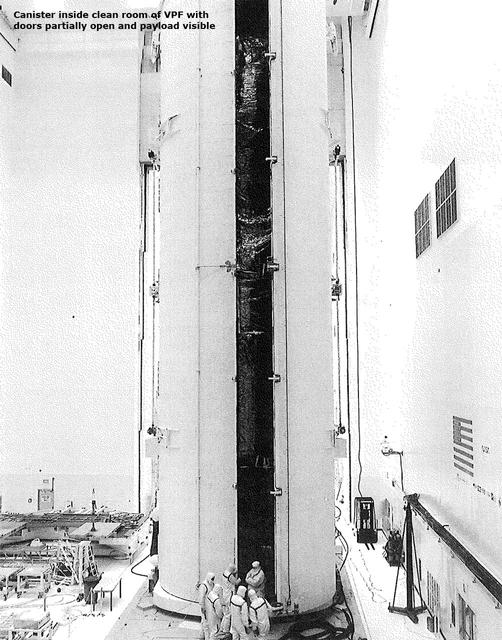 Canister inside the clean room of VPF with doors partially open and payload visible