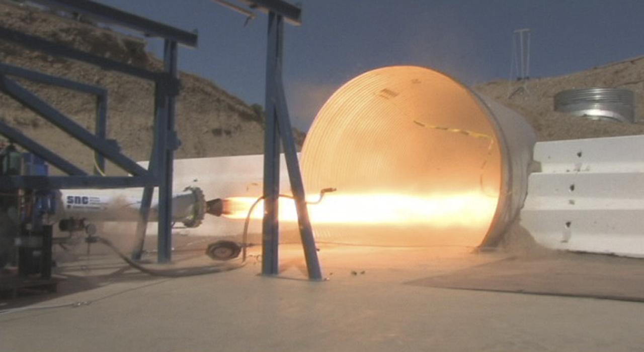 POWAY, Calif. – During NASA's Commercial Crew Development Round 1 CCDev1 activities, the rocket motor under development by Sierra Nevada Corp. for its Dream Chaser spacecraft successfully fires at the company's rocket test facility located near San Diego. NASA team members reviewed the motor's system and then watched it fire three times in one day, including one firing under vacuum ignition conditions. The tests, which simulated a complete nominal mission profile, demonstrated the multiple restart capability of Sierra Nevada's hybrid rocket. Two of the company's designed and developed hybrid rocket motors will be used as the main propulsion system on the Dream Chaser after launching aboard an Atlas V rocket. Dream Chaser is one of five systems NASA invested in during CCDev1 in order to aid in the innovation and development of American-led commercial capabilities for crew transportation and rescue services to and from the International Space Station and other low Earth orbit destinations. In 2011, NASA's Commercial Crew Program CCP entered into another funded Space Act Agreement with Sierra Nevada for the second round of commercial crew development CCDev2) so the company could further develop its Dream Chaser spacecraft for NASA transportation services. For information about CCP, visit www.nasa.gov/commercialcrew. Photo credit: Sierra Nevada Corp.