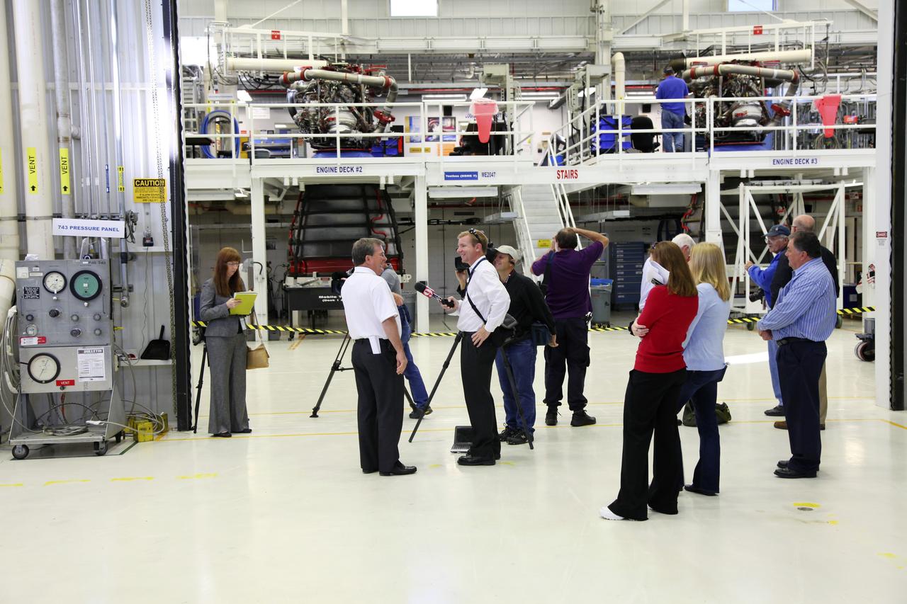 CAPE CANAVERAL, Fla. – In the Space Shuttle Main Engine Processing Facility at NASA’s Kennedy Space Center in Florida, media representatives are on hand for the installation of a Pratt Whitney Rocketdyne space shuttle main engine (SSME) into a transportation canister. This is the second of the 15 engines used during the Space Shuttle Program to be prepared for transfer to NASA's Stennis Space Center in Mississippi. The engines will be stored at Stennis for future use on NASA's new heavy-lift rocket, the Space Launch System (SLS), which will carry NASA's new Orion spacecraft, cargo, equipment and science experiments to space. For more information, visit http://www.nasa.gov/shuttle. Photo credit: NASA/Gianni Woods
