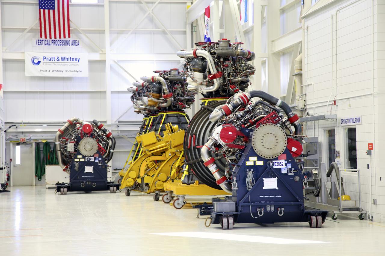 CAPE CANAVERAL, Fla. – Space shuttle main engines line the wall of the Space Shuttle Main Engine Processing Facility at NASA’s Kennedy Space Center in Florida. This is the second of the 15 engines used during the Space Shuttle Program to be prepared for transfer to NASA's Stennis Space Center in Mississippi. The engines will be stored at Stennis for future use on NASA's new heavy-lift rocket, the Space Launch System (SLS), which will carry NASA's new Orion spacecraft, cargo, equipment and science experiments to space. For more information, visit http://www.nasa.gov/shuttle. Photo credit: NASA/Gianni Woods