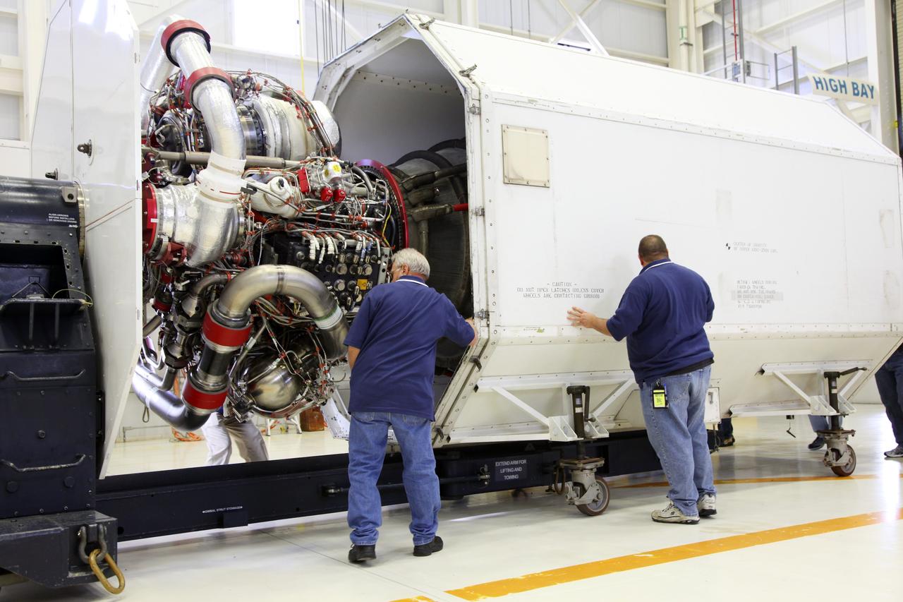 CAPE CANAVERAL, Fla. – In the Space Shuttle Main Engine Processing Facility at NASA’s Kennedy Space Center in Florida, technicians oversee the installation of a Pratt Whitney Rocketdyne space shuttle main engine (SSME) into a transportation canister. This is the second of the 15 engines used during the Space Shuttle Program to be prepared for transfer to NASA's Stennis Space Center in Mississippi. The engines will be stored at Stennis for future use on NASA's new heavy-lift rocket, the Space Launch System (SLS), which will carry NASA's new Orion spacecraft, cargo, equipment and science experiments to space. For more information, visit http://www.nasa.gov/shuttle. Photo credit: NASA/Gianni Woods
