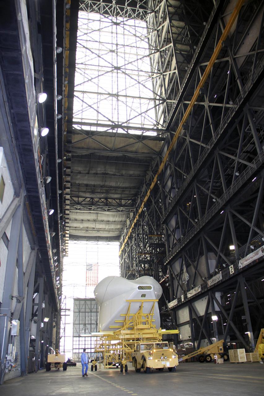 CAPE CANAVERAL, Fla. -- In the transfer aisle of the Vehicle Assembly Building at NASA’s Kennedy Space Center in Florida, the tail cone for space shuttle Discovery’s three replica shuttle main engines (RSMEs) is being transported to Orbiter Processing Facility-1. The tail cone will be installed around Discovery’s RSMEs for protection.     The work is part of the Space Shuttle Program’s transition and retirement processing of shuttle Discovery. Discovery is being prepared for display at the Smithsonian’s National Air and Space Museum, Steven F. Udvar-Hazy Center in Chantilly, Va. For more information, visit http://www.nasa.gov/shuttle.  Photo credit: NASA/Jim Grossmann