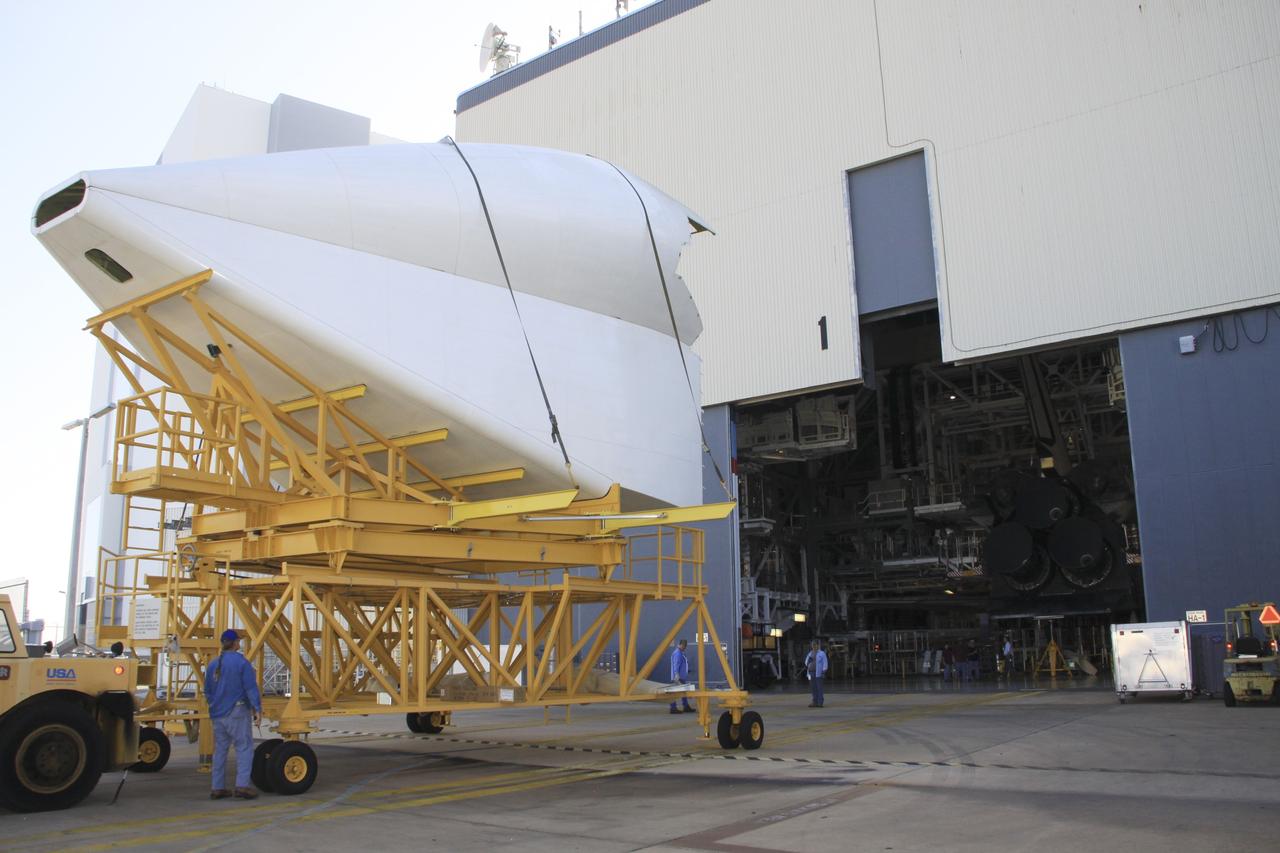CAPE CANAVERAL, Fla. -- The tail cone for space shuttle Discovery’s three replica shuttle main engines (RSMEs) arrives at Orbiter Processing Facility-1 at NASA’s Kennedy Space Center in Florida. The tail cone will be installed around Discovery’s RSMEs for protection.    The work is part of the Space Shuttle Program’s transition and retirement processing of shuttle Discovery. Discovery is being prepared for display at the Smithsonian’s National Air and Space Museum, Steven F. Udvar-Hazy Center in Chantilly, Va. For more information, visit http://www.nasa.gov/shuttle.  Photo credit: NASA/Jim Grossmann