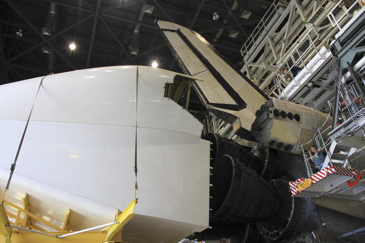 CAPE CANAVERAL, Fla. -- Inside Orbiter Processing Facility-1 at NASA’s Kennedy Space Center in Florida, a technician monitors the progress as the tail cone is installed around space shuttle Discovery’s three replica shuttle main engines for protection.    The work is part of the Space Shuttle Program’s transition and retirement processing of shuttle Discovery. Discovery is being prepared for display at the Smithsonian’s National Air and Space Museum, Steven F. Udvar-Hazy Center in Chantilly, Va. For more information, visit http://www.nasa.gov/shuttle.  Photo credit: NASA/Jim Grossmann