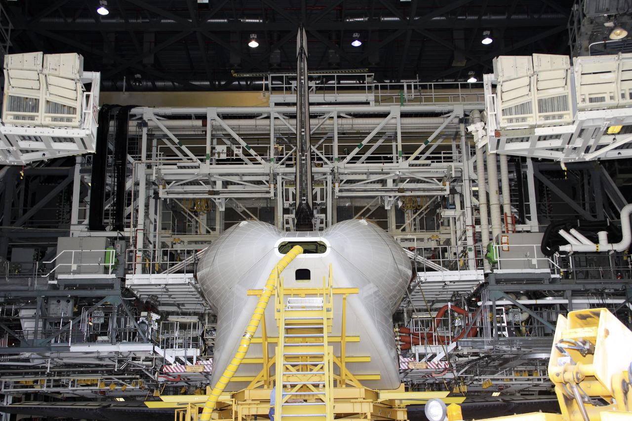 CAPE CANAVERAL, Fla. -- Inside Orbiter Processing Facility-1 at NASA’s Kennedy Space Center in Florida, the tail cone is installed around space shuttle Discovery’s three replica shuttle main engines for protection.    The work is part of the Space Shuttle Program’s transition and retirement processing of shuttle Discovery. Discovery is being prepared for display at the Smithsonian’s National Air and Space Museum, Steven F. Udvar-Hazy Center in Chantilly, Va. For more information, visit http://www.nasa.gov/shuttle.  Photo credit: NASA/Jim Grossmann