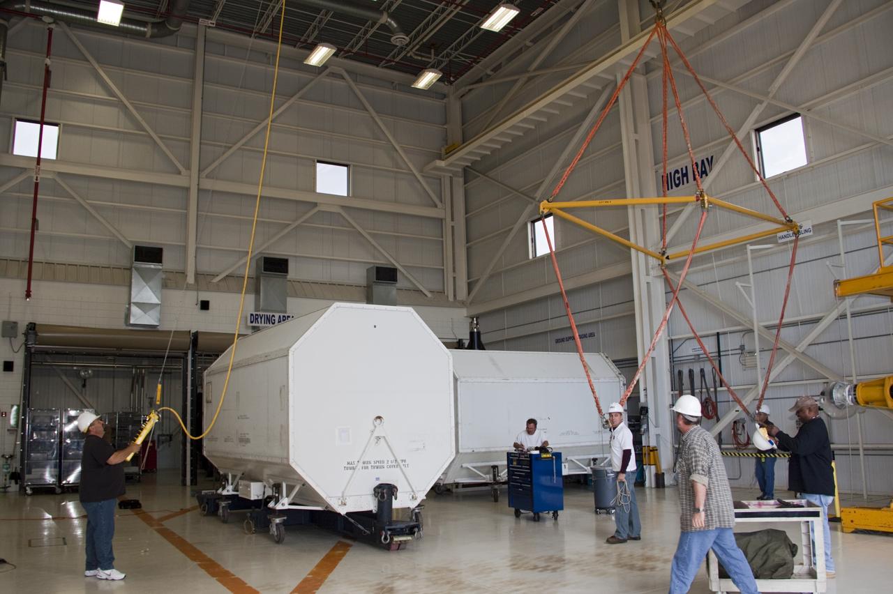 CAPE CANAVERAL, Fla. – In the Space Shuttle Main Engine Processing Facility at NASA’s Kennedy Space Center in Florida, preparations are under way to lift a transportation canister containing a Pratt & Whitney Rocketdyne space shuttle main engine (SSME) onto a flatbed trailer. This is the second of the 15 engines used during the Space Shuttle Program to be transported to NASA's Stennis Space Center in Mississippi. The engines will be stored at Stennis for future use on NASA's new heavy-lift rocket, the Space Launch System (SLS), which will carry NASA's new Orion spacecraft, cargo, equipment and science experiments to space. For more information, visit http://www.nasa.gov/shuttle. Photo credit: NASA/Jim Grossmann