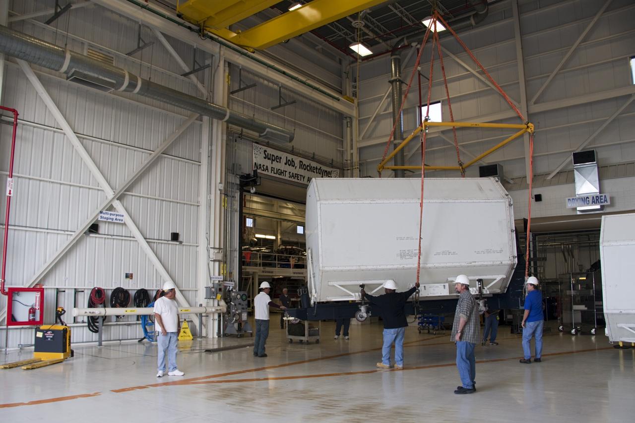 CAPE CANAVERAL, Fla. – In the Space Shuttle Main Engine Processing Facility at NASA’s Kennedy Space Center in Florida, a transportation canister containing a Pratt & Whitney Rocketdyne space shuttle main engine (SSME) glides above the floor toward a flatbed trailer. This is the second of the 15 engines used during the Space Shuttle Program to be transported to NASA's Stennis Space Center in Mississippi. The engines will be stored at Stennis for future use on NASA's new heavy-lift rocket, the Space Launch System (SLS), which will carry NASA's new Orion spacecraft, cargo, equipment and science experiments to space. For more information, visit http://www.nasa.gov/shuttle. Photo credit: NASA/Jim Grossmann
